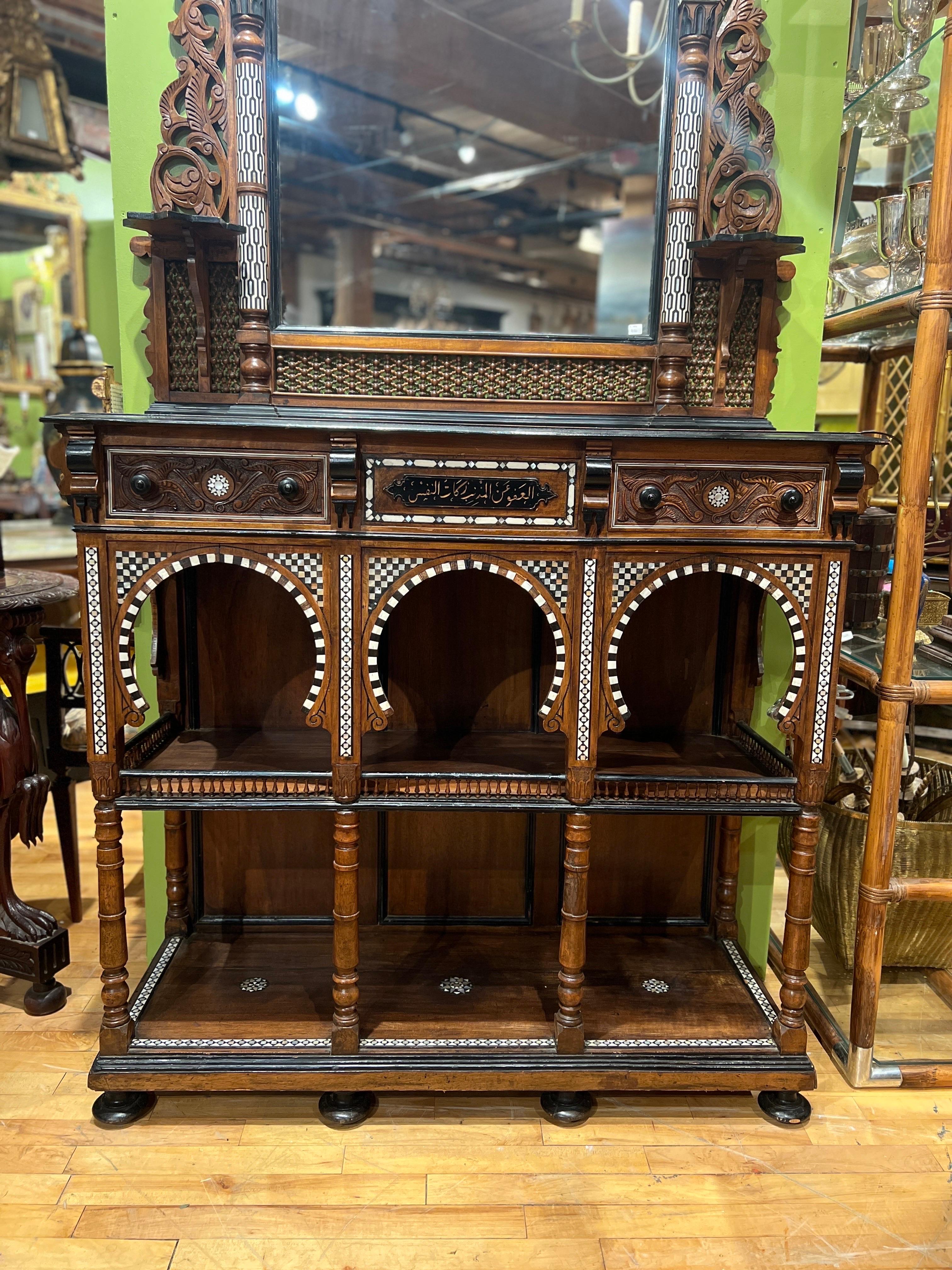 Attributed to Giuseppe Parvis (Egyptian/Italian 1831-1909), circa 1880. 

Two part form, tall architectural framed mirror with hardwood, bone, ebony and mother of pearl inlays, pierced and relief carved panels, the lower back splash with intricate