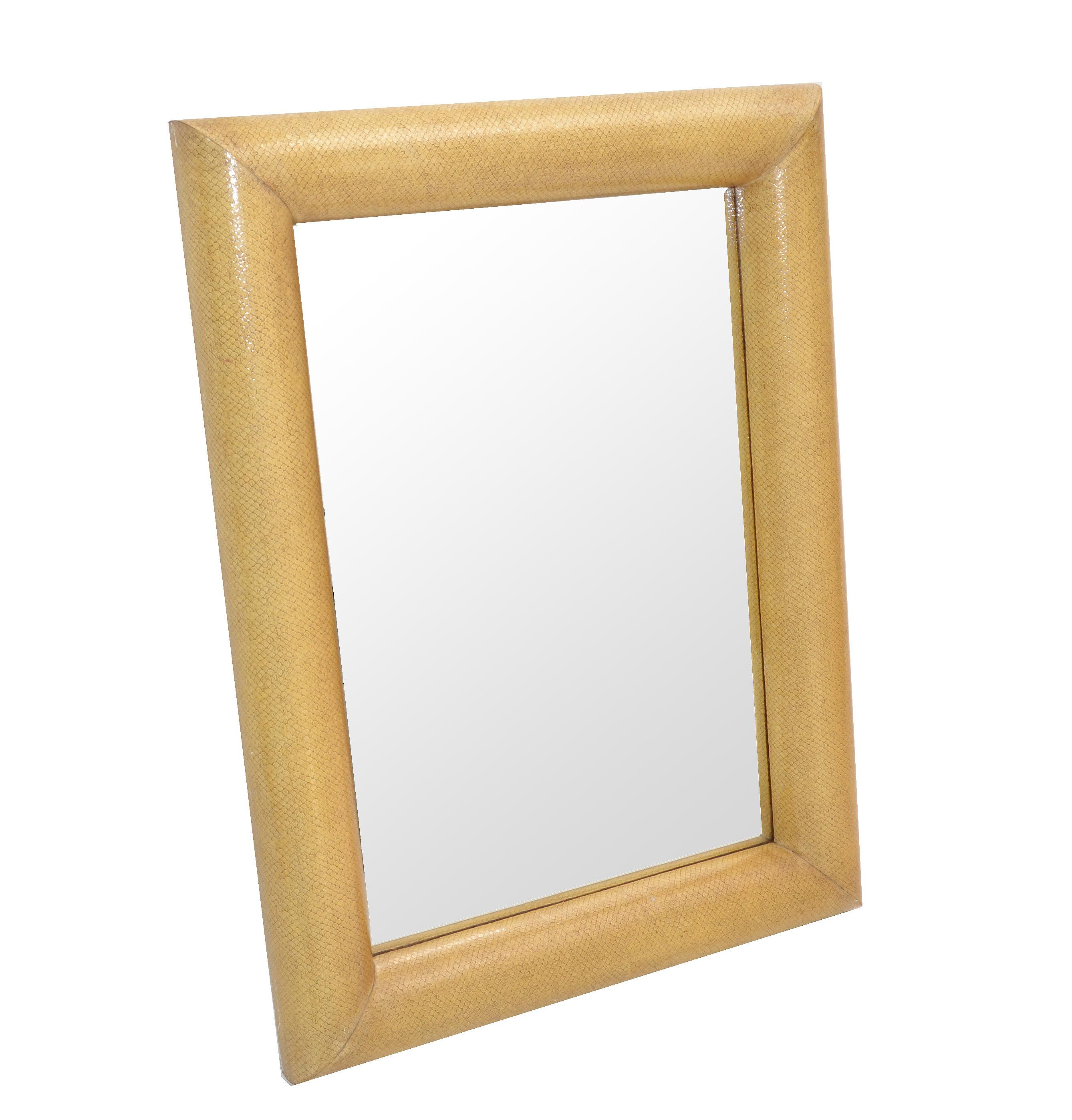 Rectangular wall mirror attributed to Karl Springer in beige snakeskin with wooden backing for secure hanging construction.
Exquisite unique look which can be hung horizontal as well as vertical.
In all original vintage condition.
Mirror Size: 21