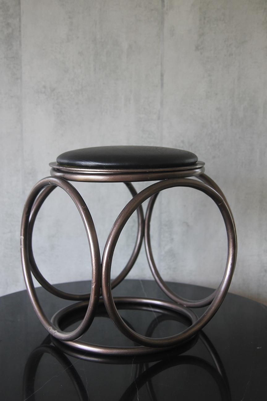 Uncover the elegance of Mid-Century Modern design with this stunning bentwood stool and ottoman. Expertly crafted in Austria, this remarkable piece showcases the iconic style of the esteemed designer Michael Thonet. With its smooth curves and
