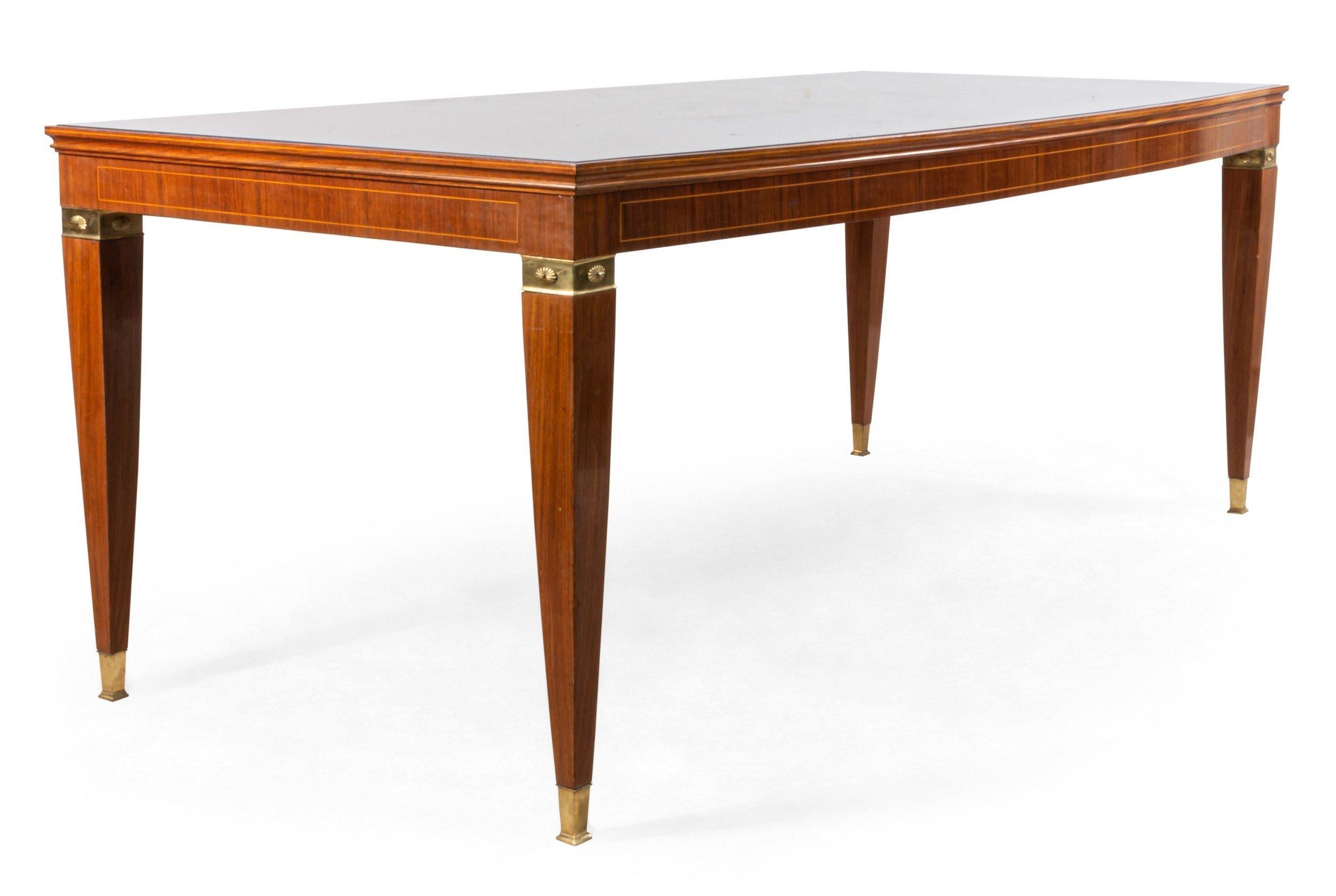Italian midcentury dining table with wood construction, red glass top, and bronze mounted legs (attributed to Paulo Buffa for Serafino Arrighi).
