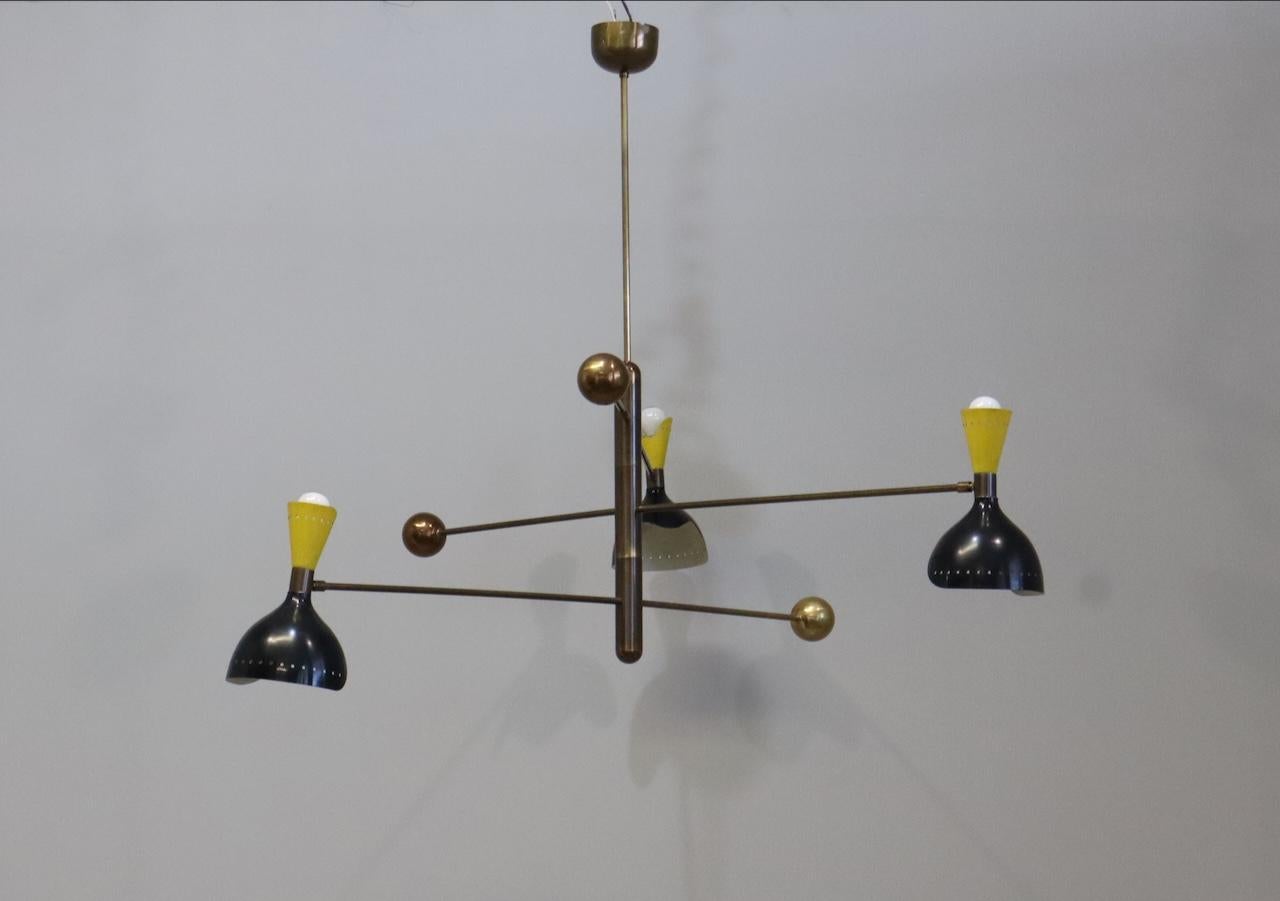 Fantastic rare chandelier  Stilnovo style. Composed of three adjustable arms with counter weight. Made of brass and metal lampshades.