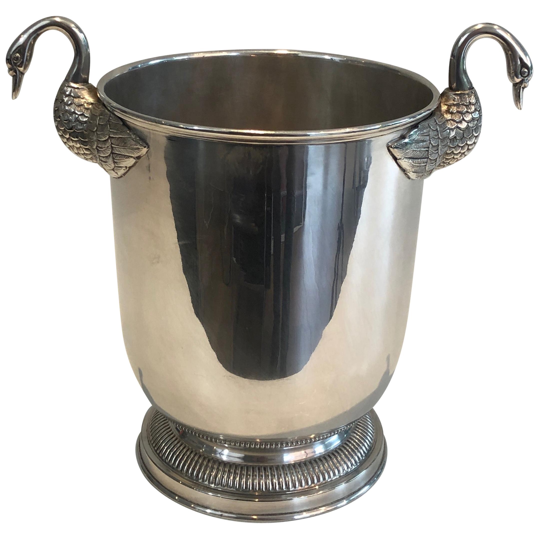 This very nice neoclassical ice bucket is made of silver plated. It has fine swan handles. This is a very nice French piece attributed to Christofle. Circa 1940.