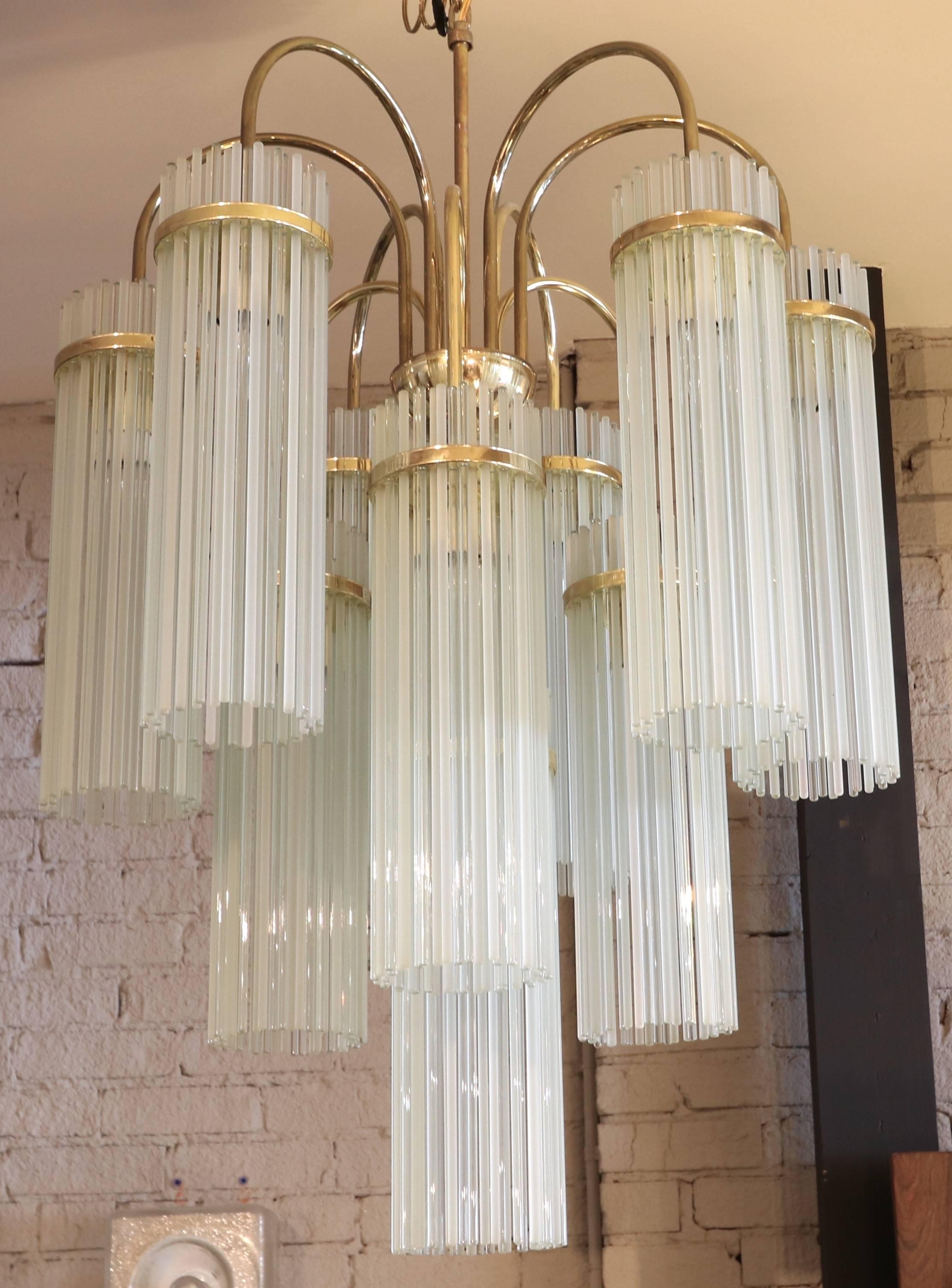 Ten-arm chandelier attributed to Gaetano Sciolari for Lightolier from the 1960s with alternating transparent and frosted glass rods with a brass frame.