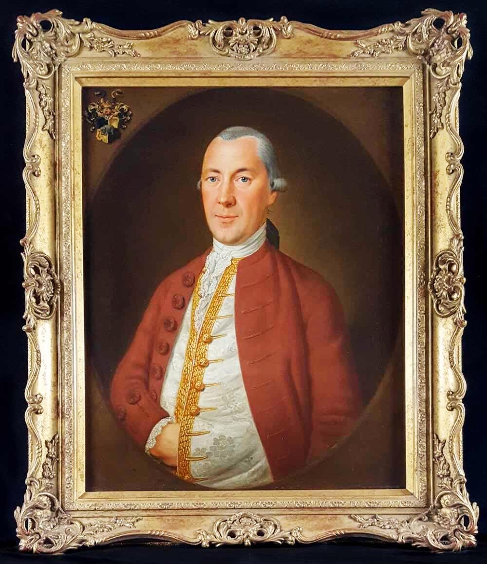I am pleased to offer this beautifully executed portrait of an aristocratic looking gentleman who has been eloquently depicted in a russet coat, white silk vest edged in gold thread. His hand is neatly tucked into his vest, a common pose often seen