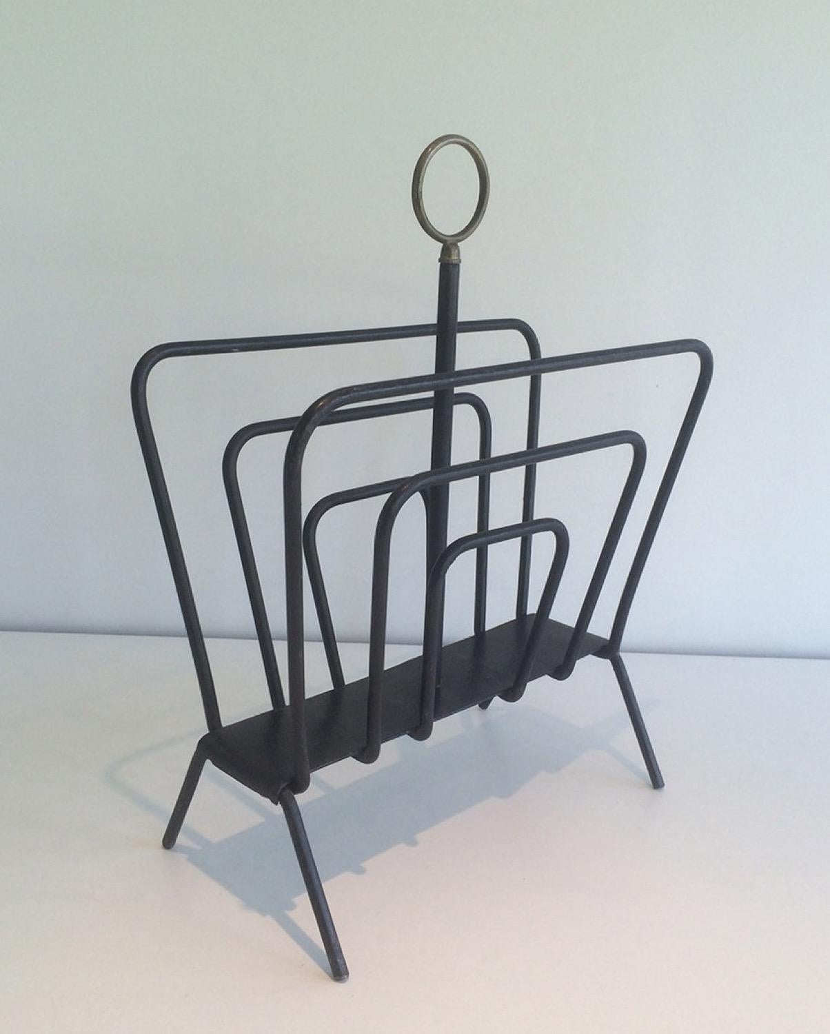 Attributed to Jacques Adnet. Black lacquered metal and brass magazine rack, French, circa 1950.