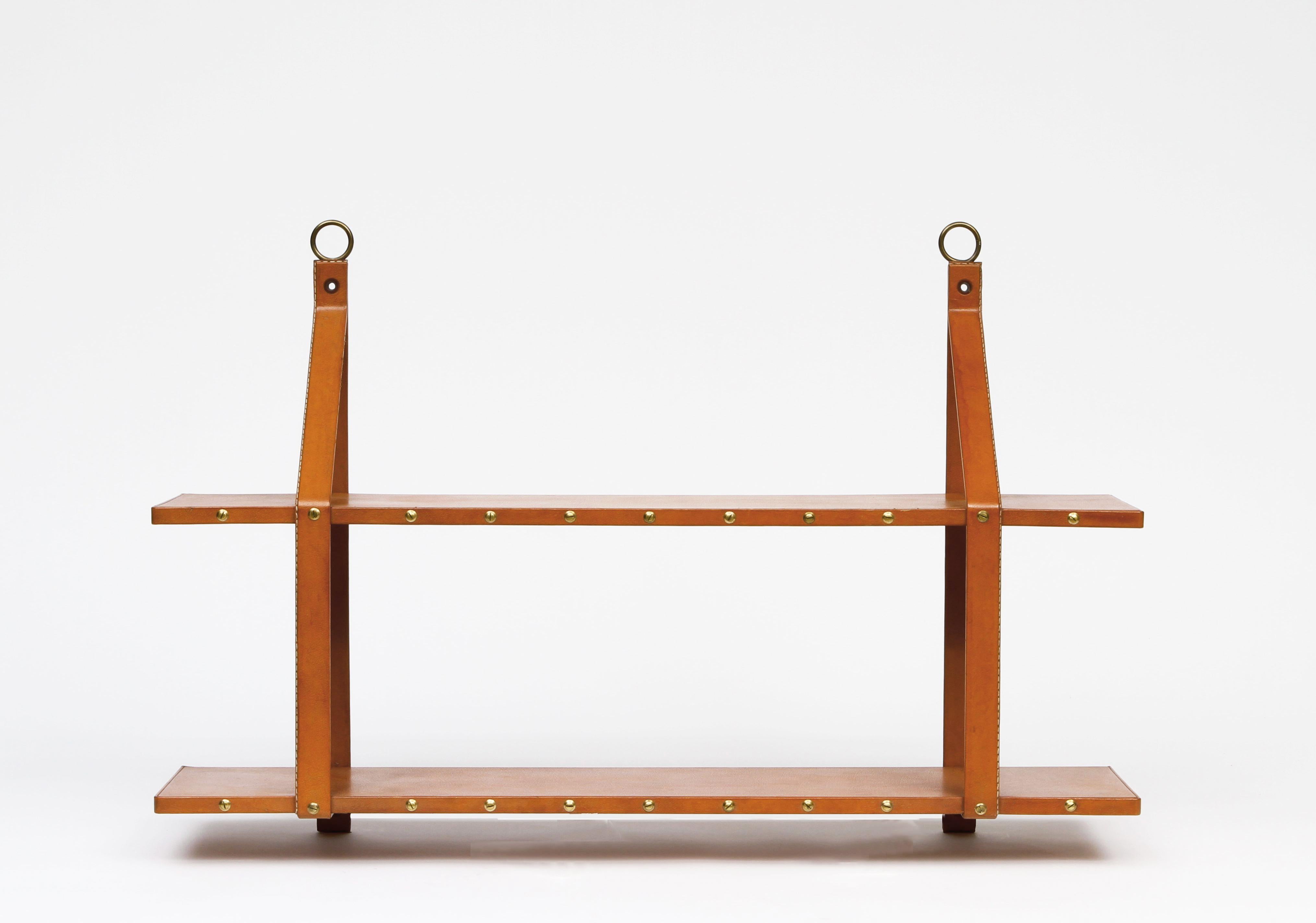 Attributed to Jacques Adnet, leather bookshelf, circa 1950
Leather covered shelf (2 levels), brass hooks and nailing. Great original condition.