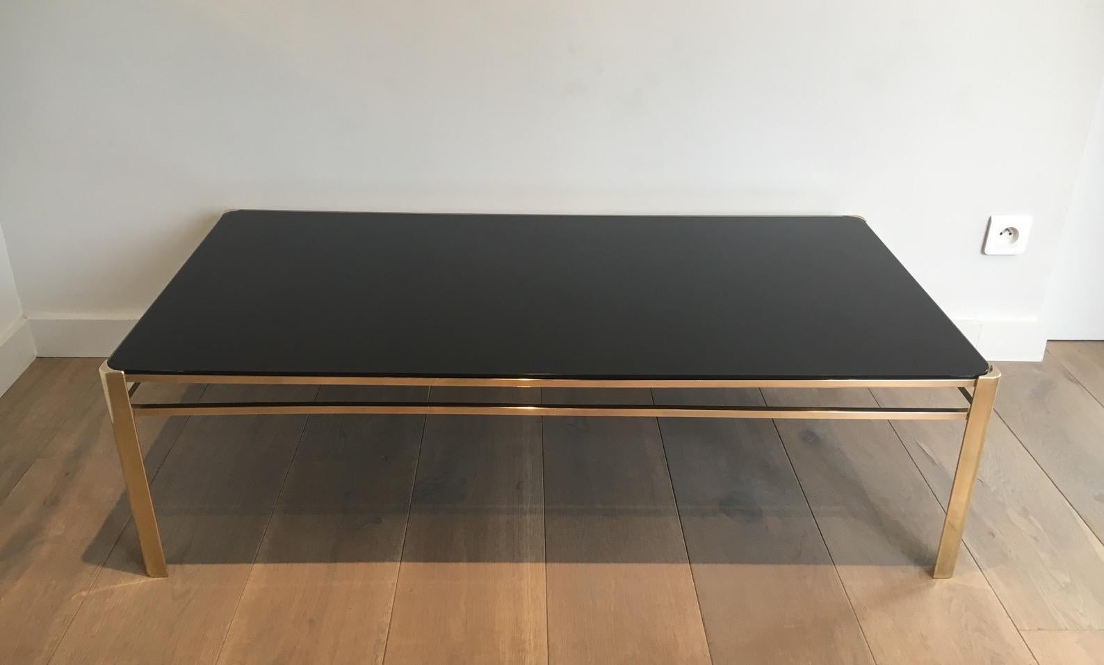 This very nice coffee table is made of bronze with a black lacquered glass top. This is a model attributed to famous french designer Jacques Quinet, circa 1970. The table is signed and numbered.