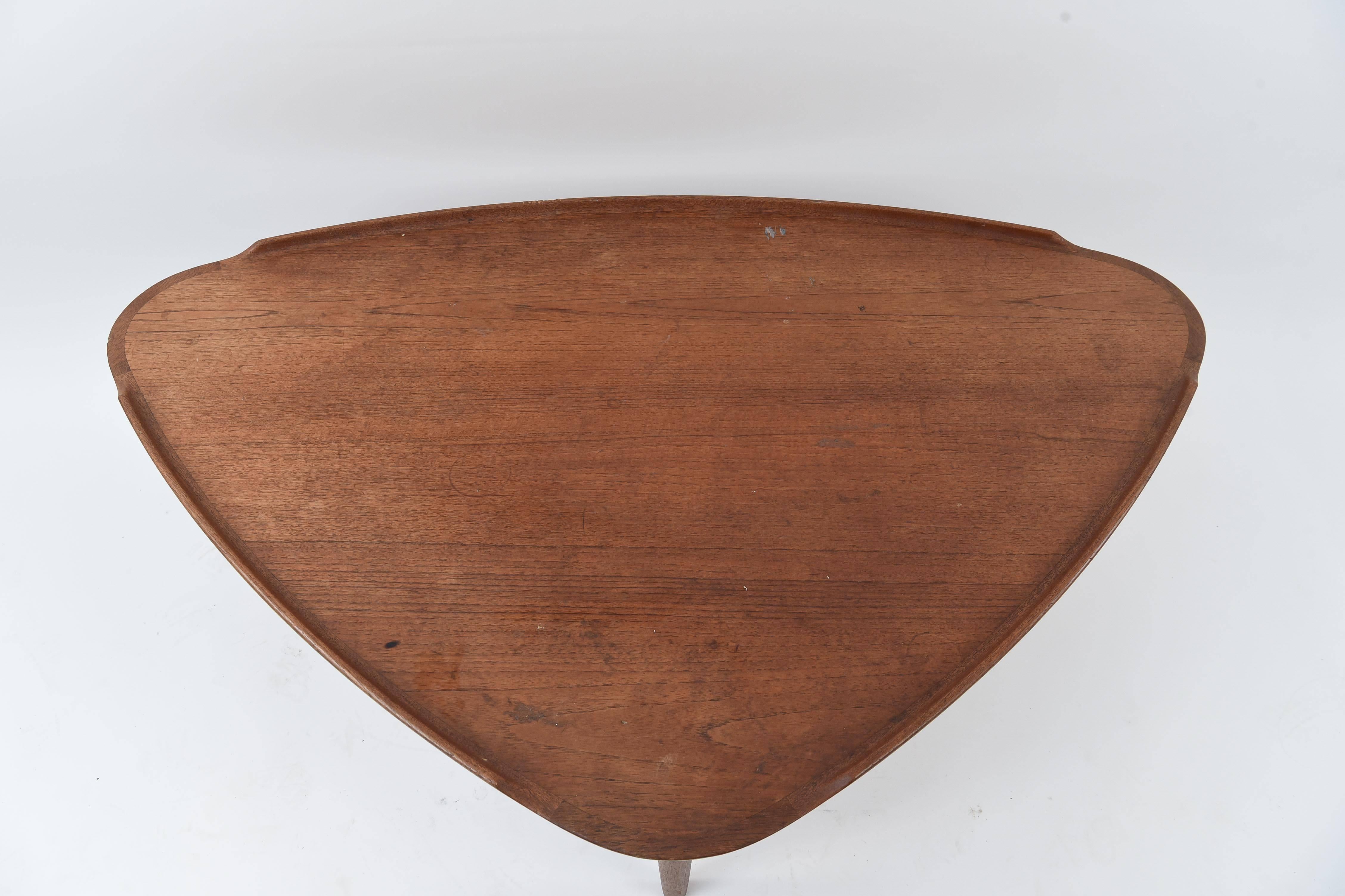 A nice shape to get away from the normal square or rectangle coffee tables! This is a wonderful piece of Danish midcentury teak wood design. Marked 