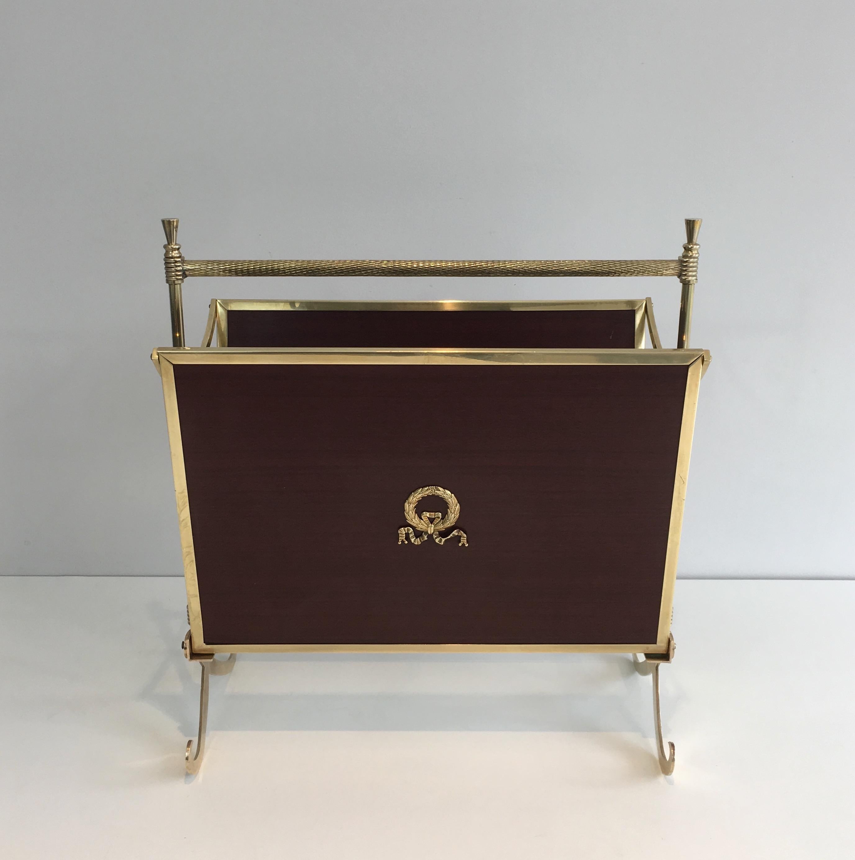 This neoclassical magazine rack is made of mahogany and brass with a glass shelf on the bottom. This piece is attributed to famous French designer Maison Jansen, circa 1940.