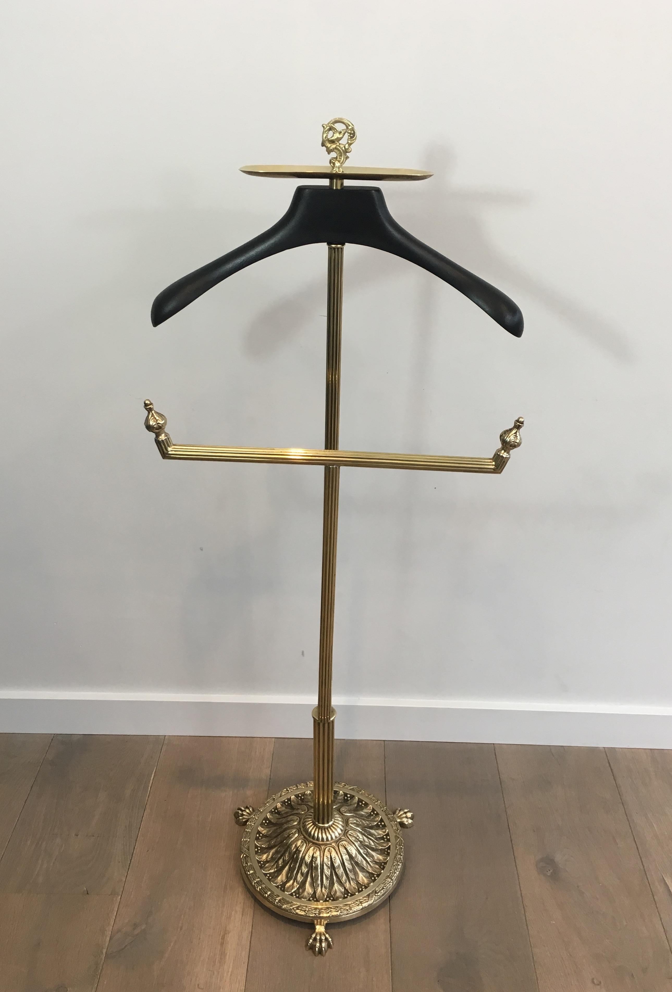 This beautiful neoclassical valet is made of brass, chiseled bronze and black lacquered wood. This is a beautiful model, attributed to famous French designer Maison Jansen, circa 1940.