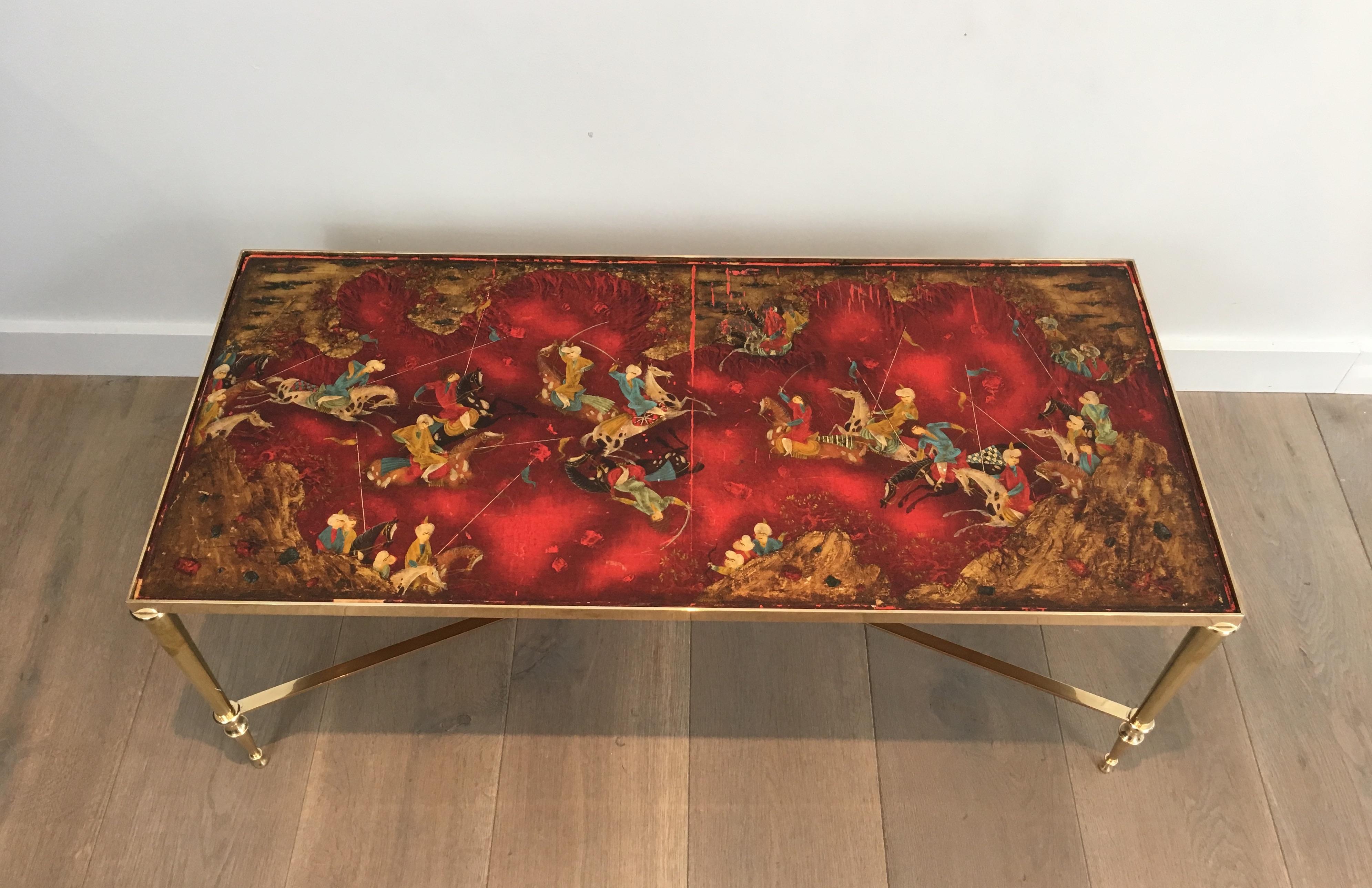 Attributed to Maison Jansen. Unique neoclassical brass coffee table with lacquered panel. The brass base has a nice brace. The lacquered panel shows a battle with Persian riders. French, circa 1940
The lacquer is a bit damaged and can have some