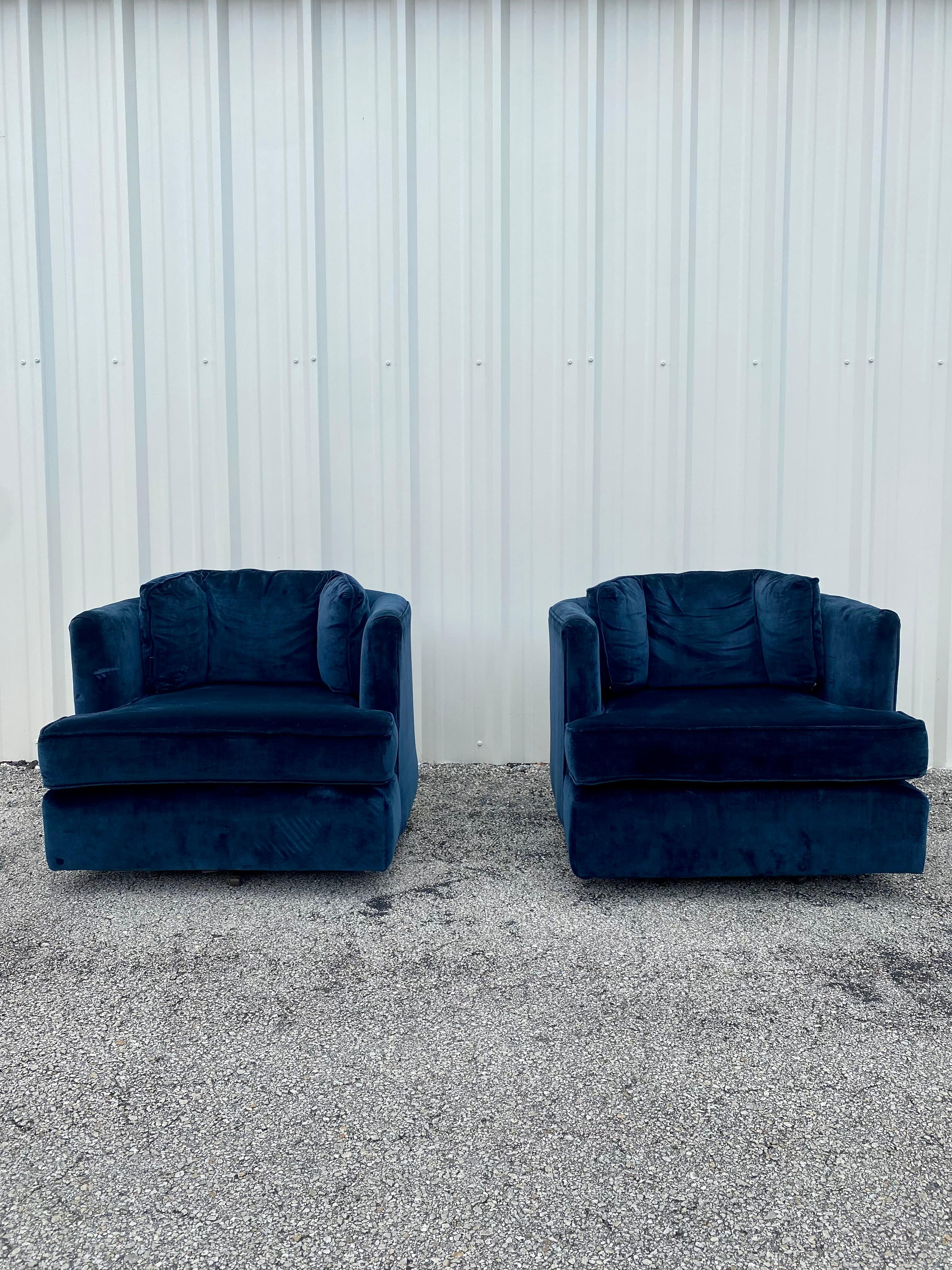 These extremely rare and stylish original navy blue velvet upholstered swivel chairs are packed with personality! Outstanding design is exhibited throughout. Their beautiful and sculptural shape are attributed to Milo Baughman. The chairs feature a