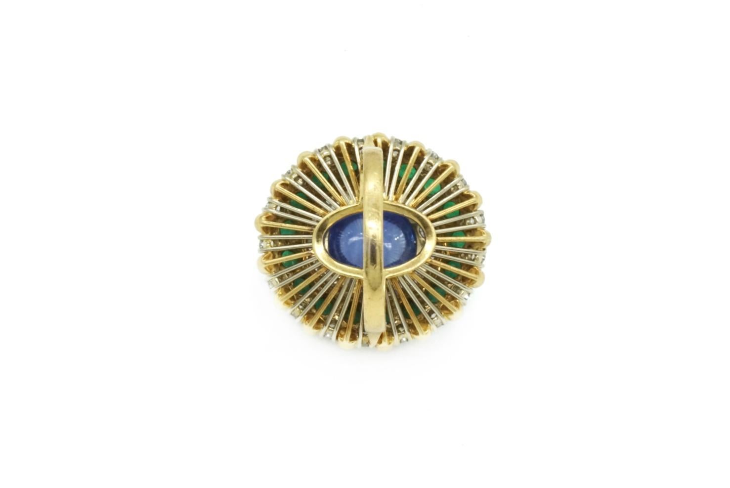 Nardi Gold, Cabochon Sapphire and Emerald and Diamond Ring

One oval cabochon sapphire ap. 6.75 cts., 32 round diamonds ap. 1.85 cts., 17 round cabochon emeralds, ap. 11.2 dwts. Size 7 1/4. With box signed Nardi. 
Made in Italy 
Circa 1960


C