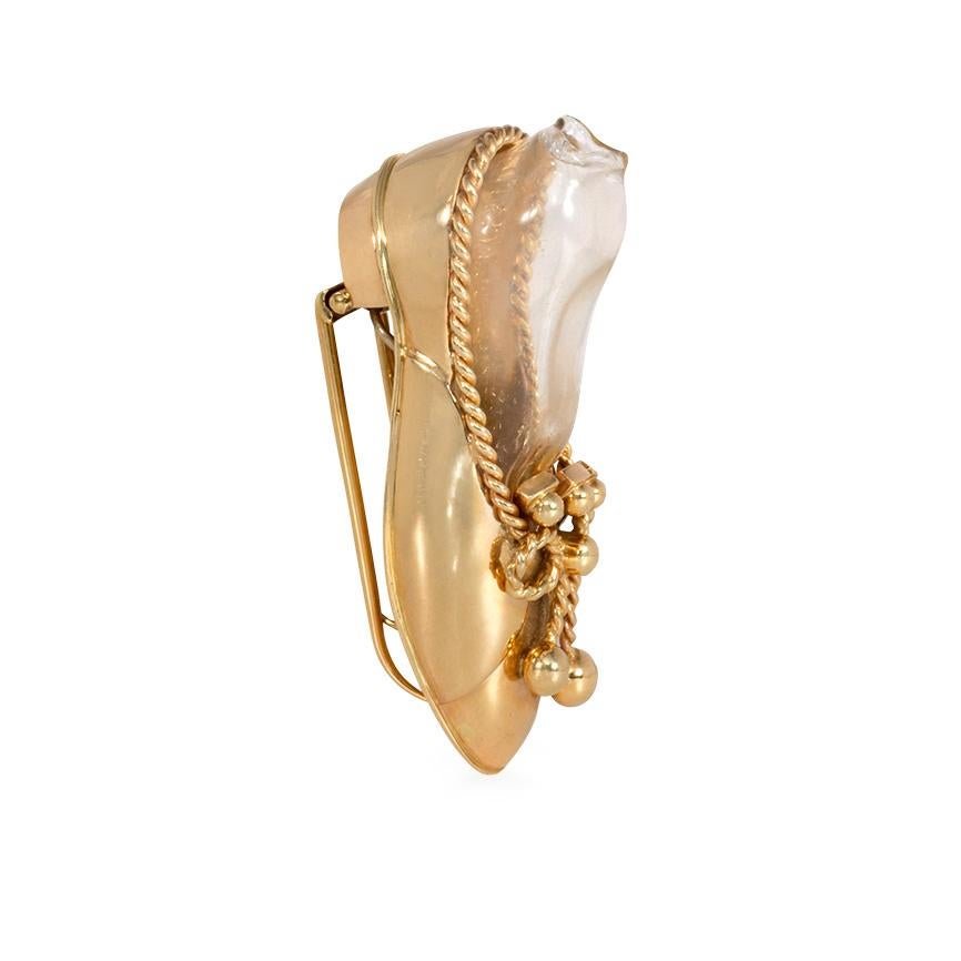A Retro gold posy brooch in the form of a shoe holding a hand blown glass vessel, in 14k.  Attributed to Paul Flato. Cf. Bray, Elizabeth Irvine, Paul Flato; Jeweler to the Stars, Woodbridge, Suffolk, United Kingdom; Antique Collectors Club, 2010, p.
