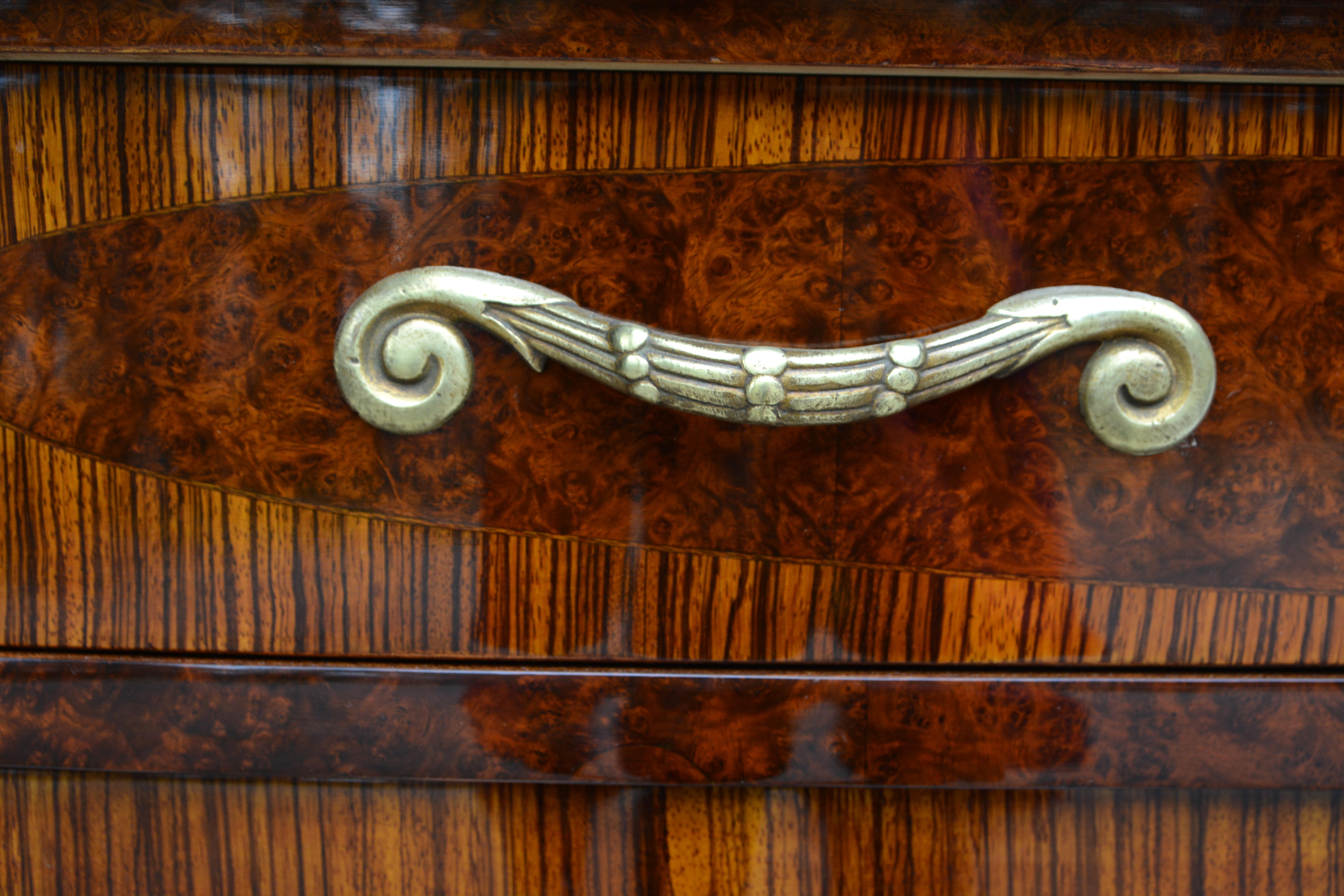 Attributed to Paul Follot - Art Deco sideboard, Paris, 1920s. Made of walnut, rosewood, and other fine woods.

Body with concave sides and fine floral inlays, a drawer and a facet cut glazed door. 

The French Art Nouveau and Art Deco designer