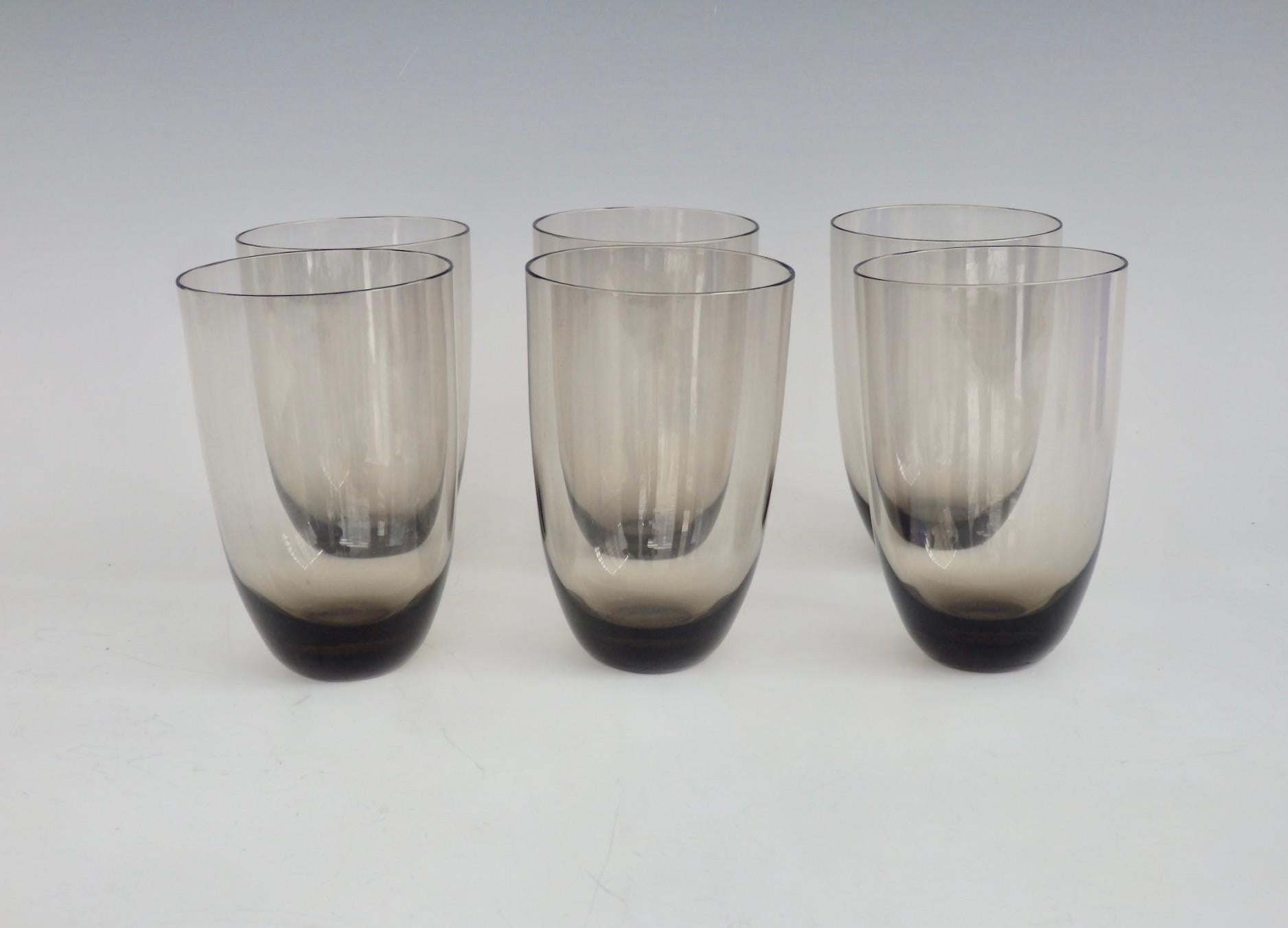 Six cocktail glasses or water tumblers. Gently curving form in smoked glass.