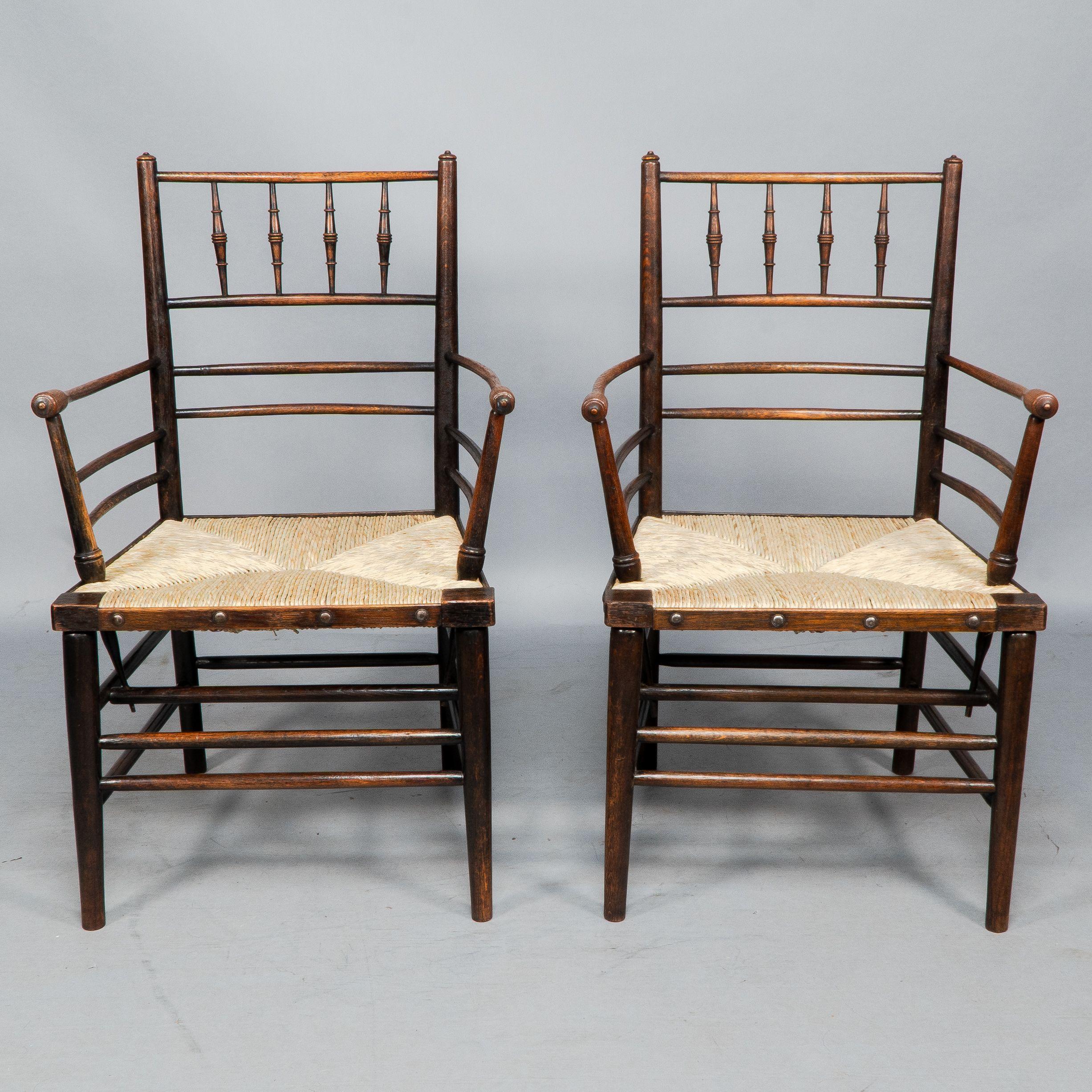 Morris & Co. Attributed to Philip Webb A rare pair of unusually large Sussex Armchairs. This original pair have been fully restored, gently dismantled, joints cleaned, glued and clamped over night, then lightly cleaned and waxed, and professionally