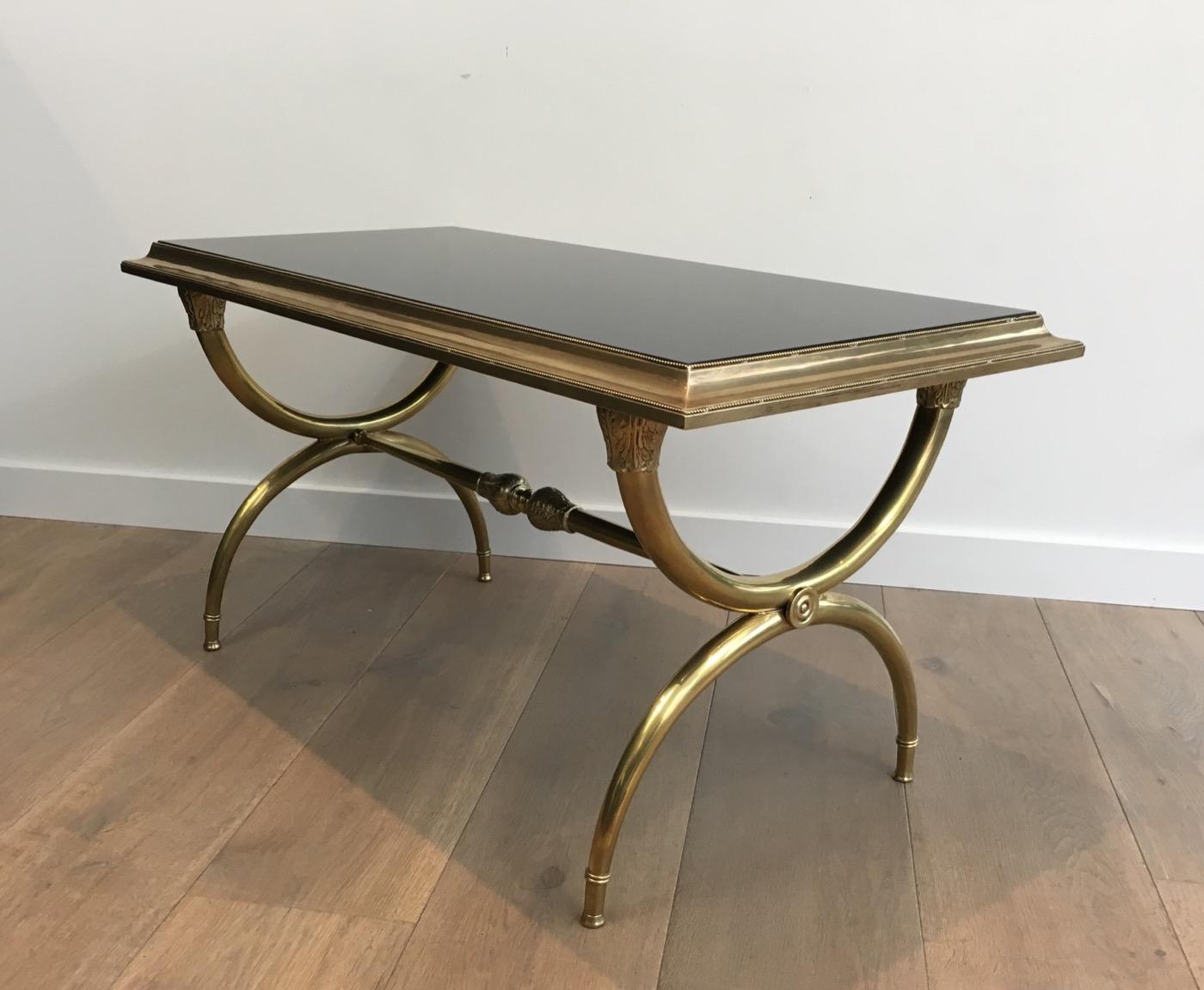 This very elegant neoclassical coffee table is made of a heavy bronze and brass base with a black lacquered glass shelf on top. This is a Fine work, attributed to famous French designer Raymond Subes, circa 1940.