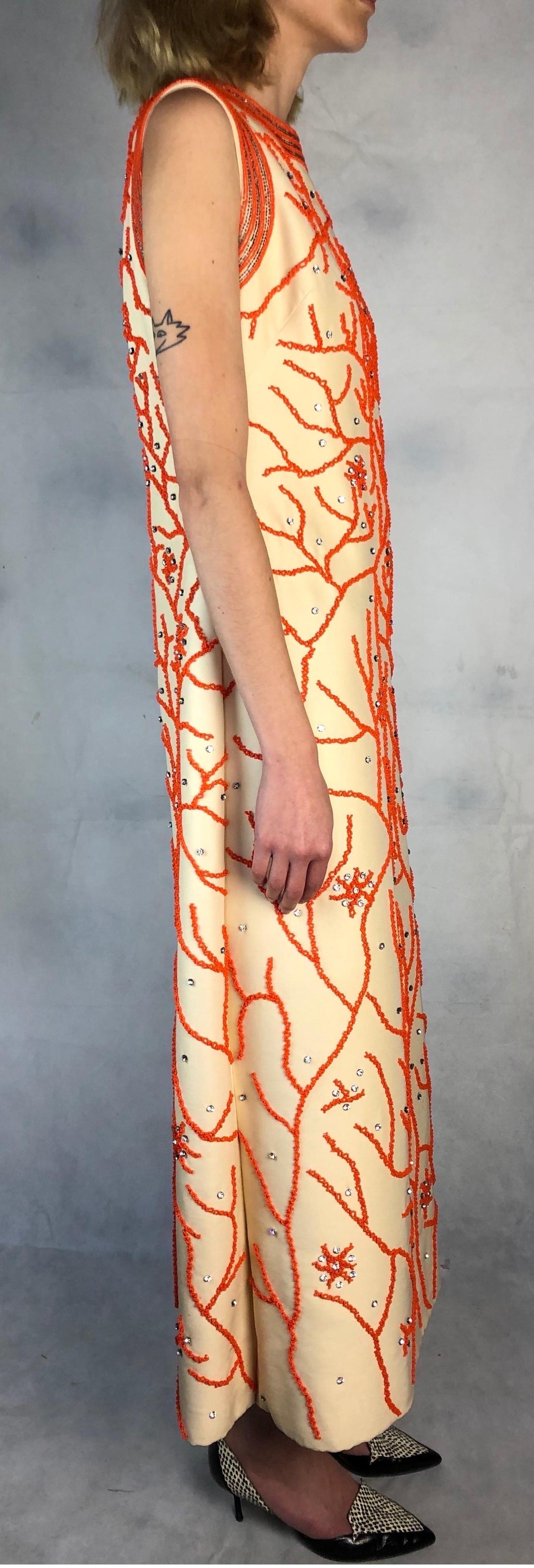 Attributed to  Valentino dress constructed with wool and silk material. Fully hand beaded with glass beads into a coral reef motif. featuring a round neck and sleeveless. Fully lined  
