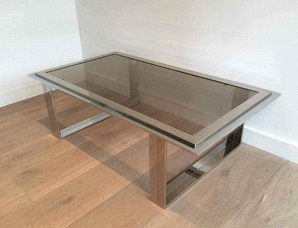 This nice design coffee table is made of chrome with a smoked glass top. This is a work in the style of famous designer Willy Rizzo, circa 1970.