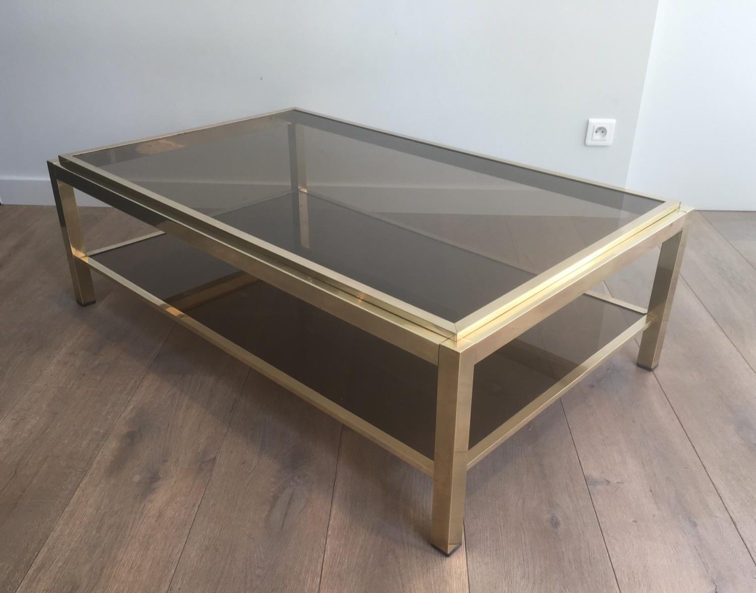 Attributed to Willy Rizzo. Exceptional Very large brass coffee table with smoked glass shelves, circa 1970.
