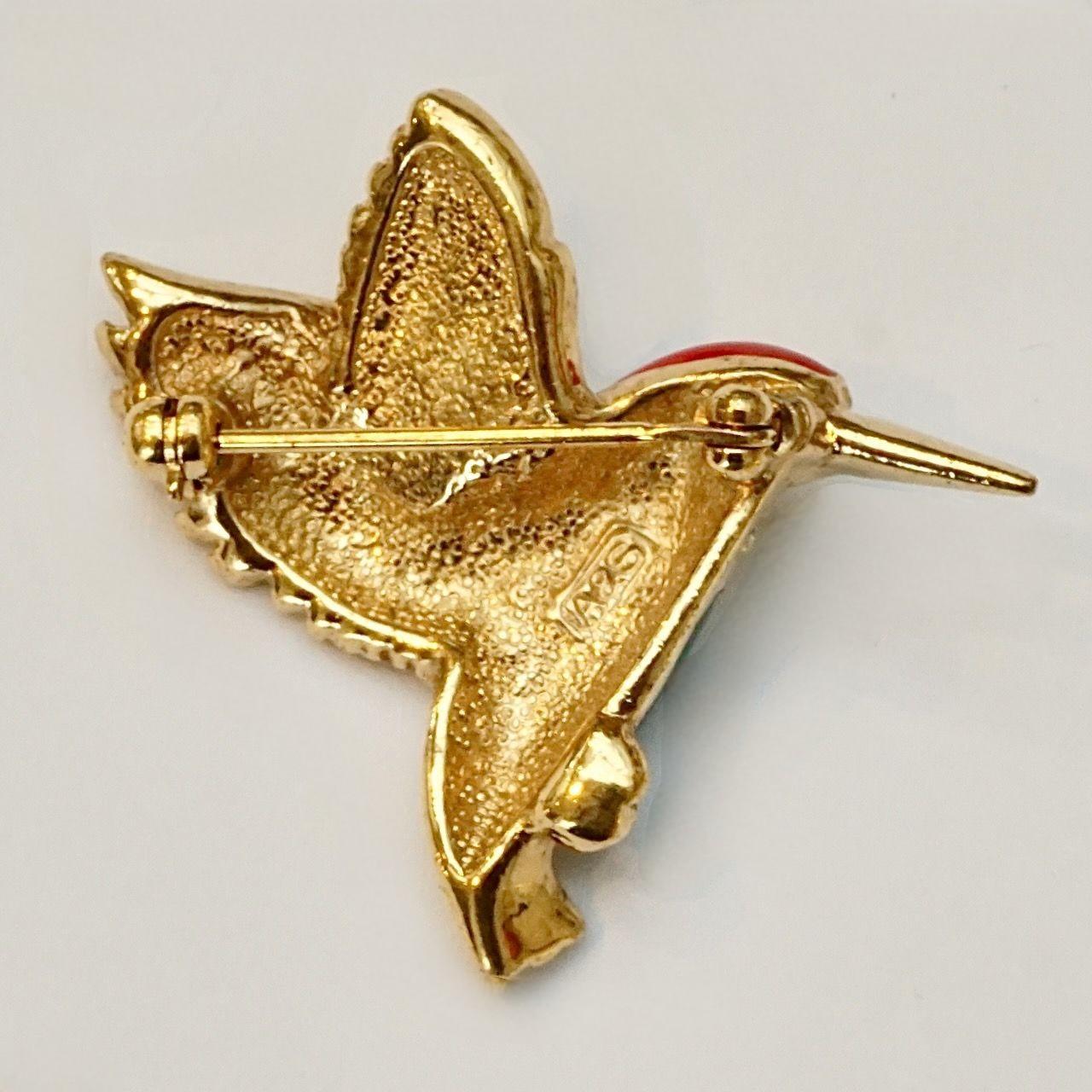 Beautiful Attwood & Sawyer gold plated bird brooch with green, blue and red enamel, and embellished with rhinestones. The eye is a green rhinestone. Measuring maximum length 3.7 cm / 1.45 inch by width 3.3 cm / 1.3 inches.

This is a high quality