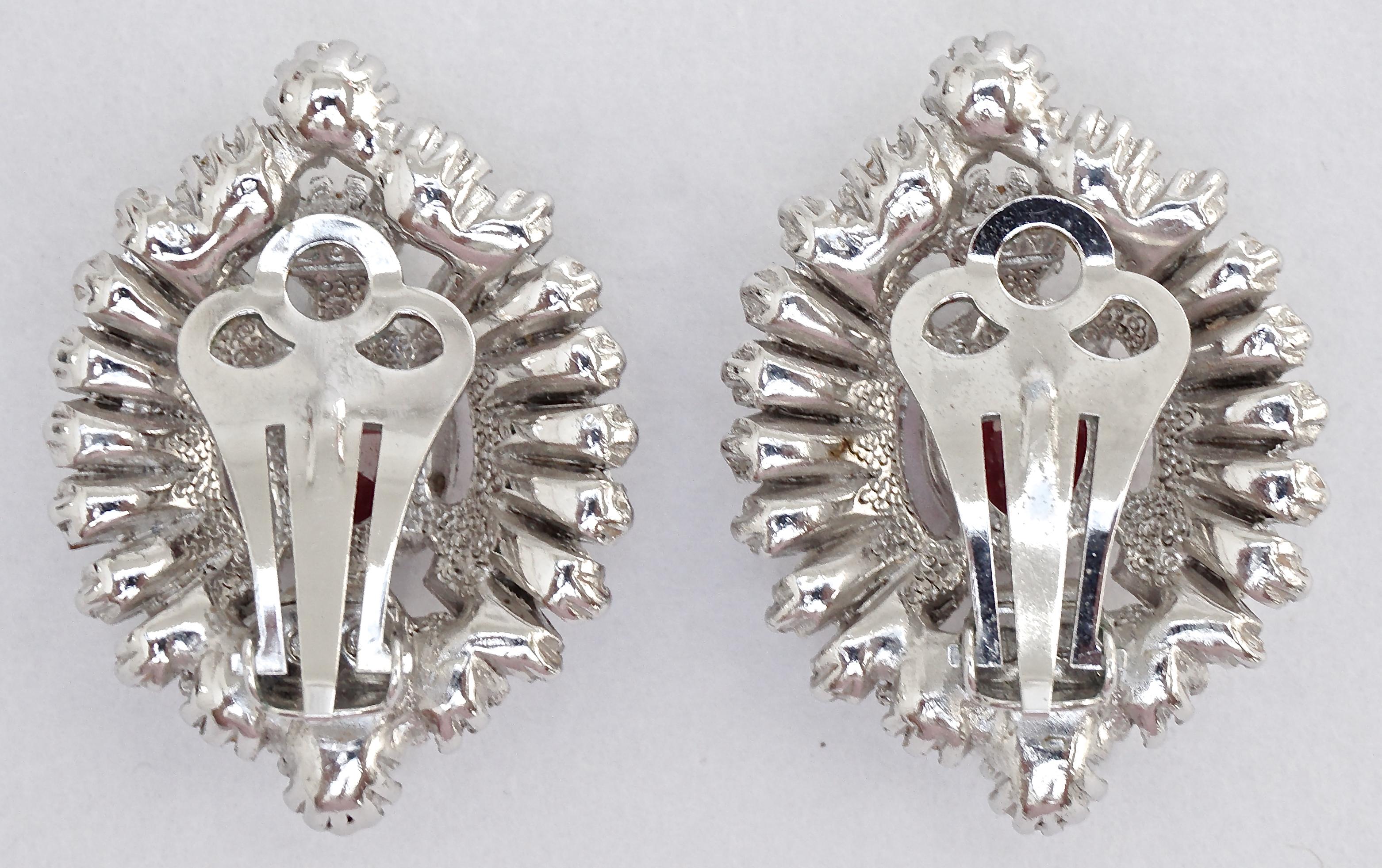Beautiful Attwood & Sawyer silver tone clip on earrings set with round and baguette clear rhinestones, and a centre ruby red rhinestone. The earrings are in very good condition, and measure 3cm / 1.18 inches by 2.2cm / .86 inch.

These sophisticated