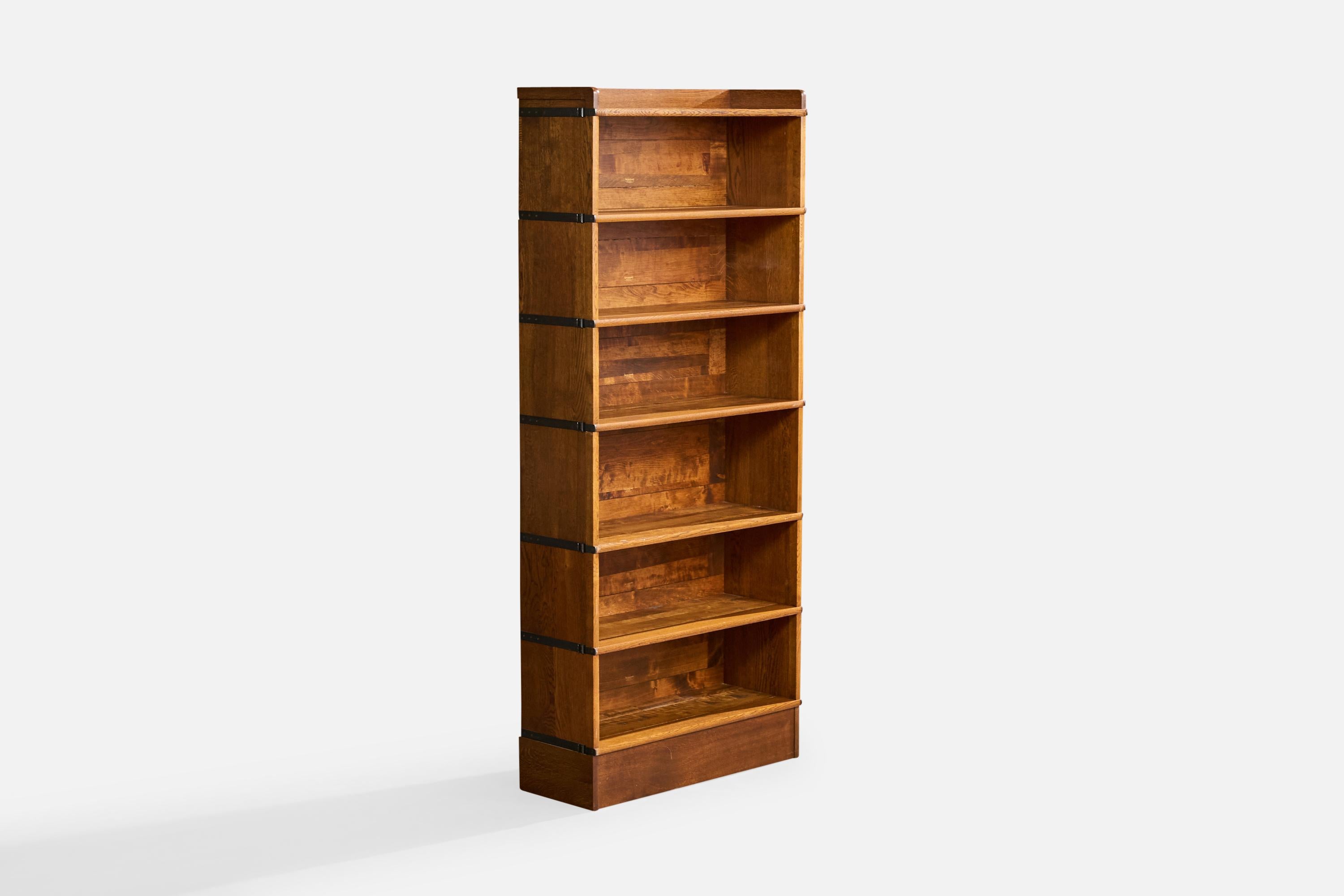 A dark-stained pine and iron bookcase produced by Åtvidaberg, Sweden, c. 1940s.

Overall Dimensions (inches): 79.125