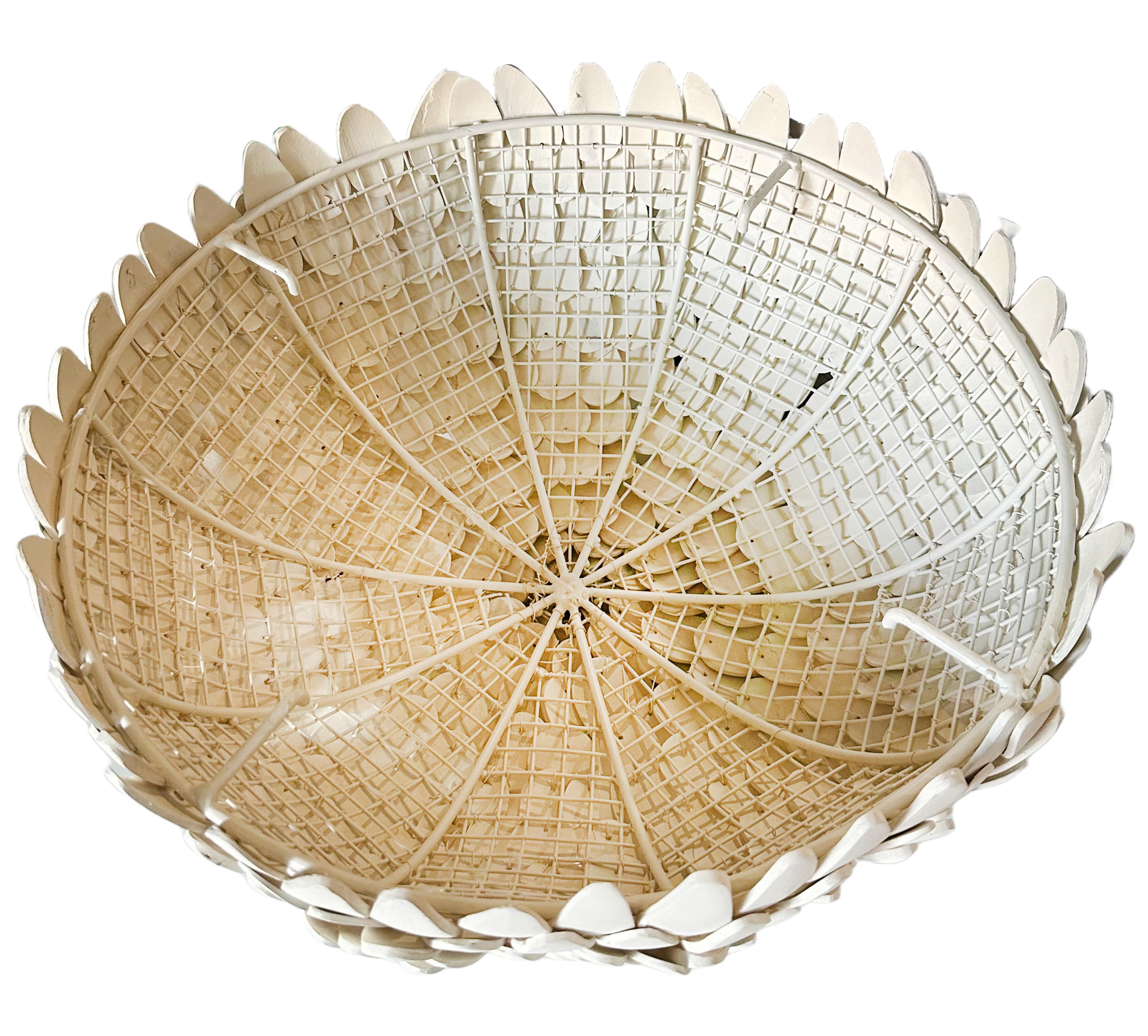 A beautifully crafted Atwater flush mount light fixture. Hand-carved and hand-strung coconut shells on a white powder-coated iron frame. A refined display of artisanal craftsmanship and organic texture. 21st century made. One of three available in