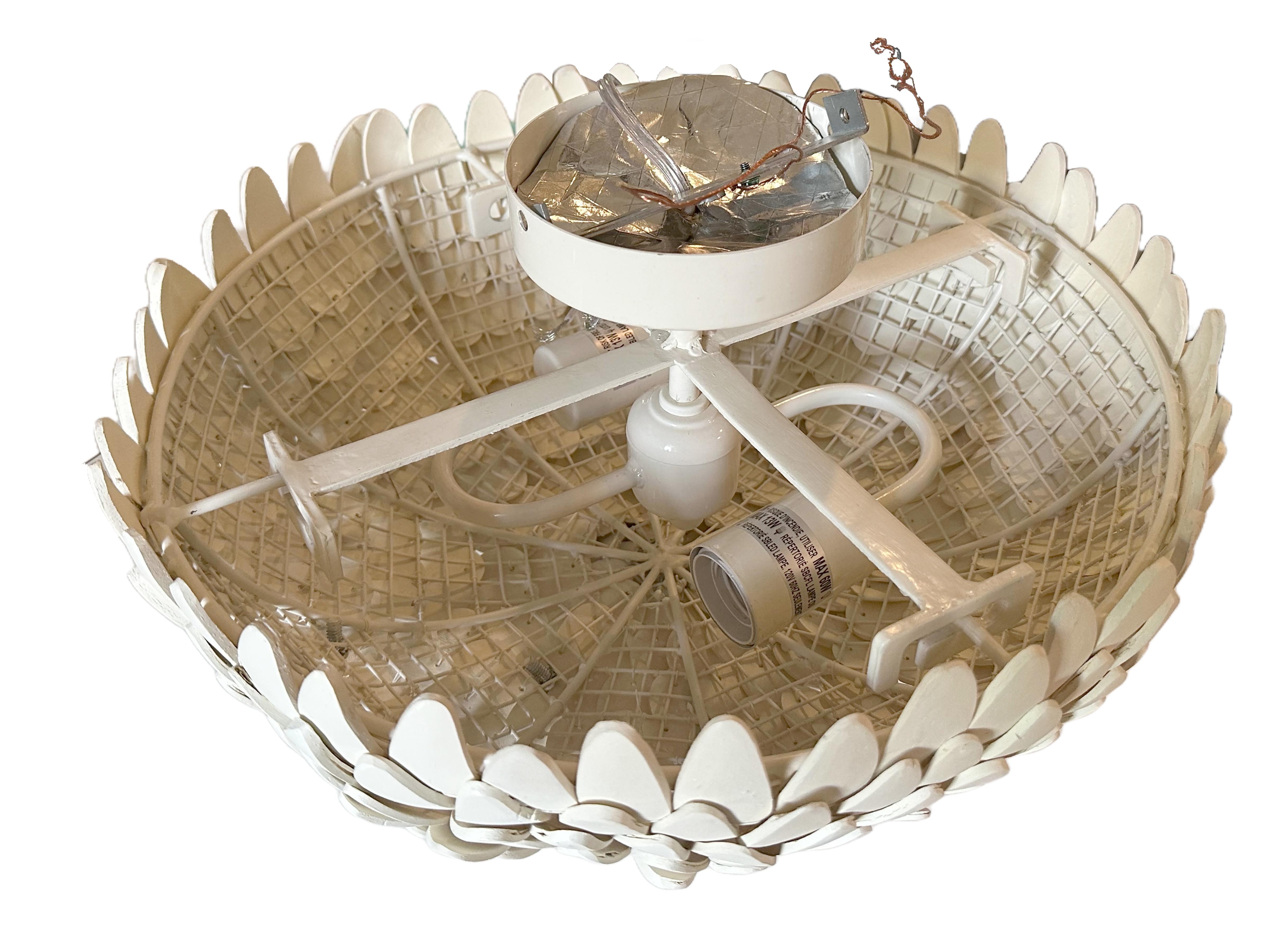 A beautifully crafted Atwater flush mount light fixture. Hand-carved and hand-strung coconut shells on a white powder-coated iron frame. A refined display of artisanal craftsmanship and organic texture. 21st century made. Three of three available in