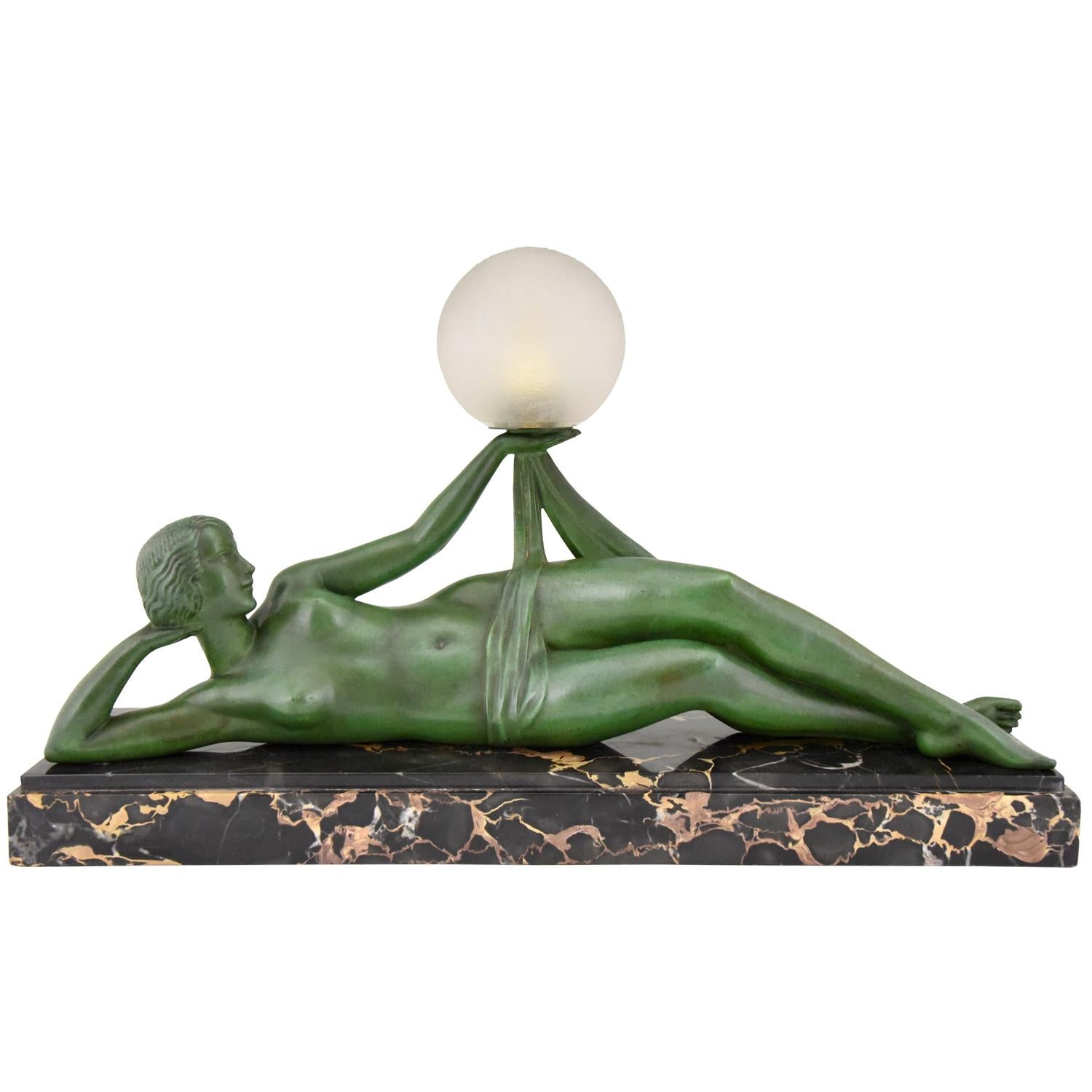 Aube, hard to find Art Deco lamp reclining nude lady with scarf holding a ball signed Fayral, pseudonym of Pierre Le Faguays.
With foundry seal of the Max Le Verrier foundry. Patinated Art Metal figure, on a Portoro marble base with an extra base