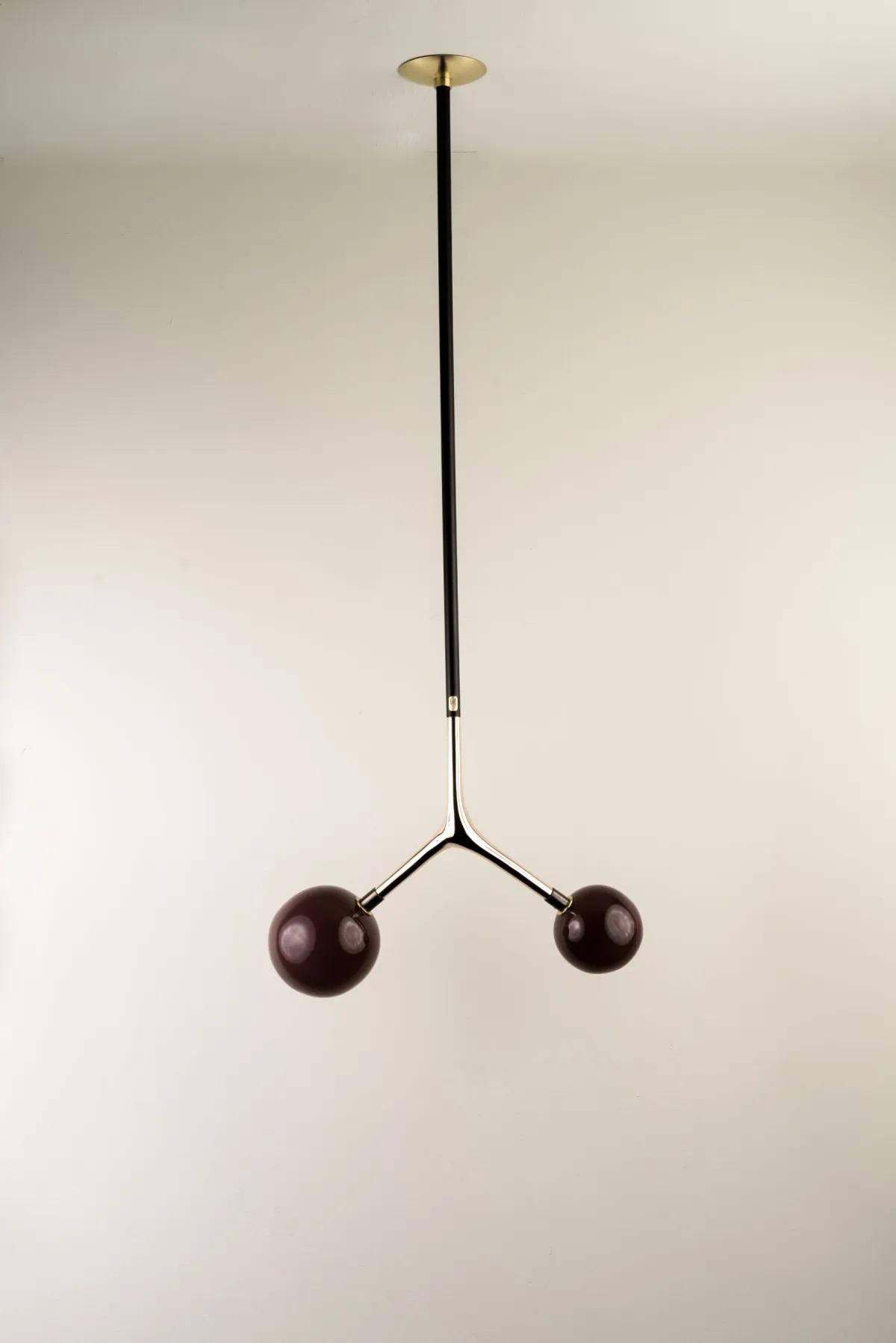 Aubergine Dupla Pendant Lamp by Isabel Moncada
Dimensions: W 45 x D 20 x H 125 cm.
Materials: Brass, cast bronze and blown glass.

Dupla hangs from the ceiling just like a branch with its fruits. The customizable length options allow play with scale