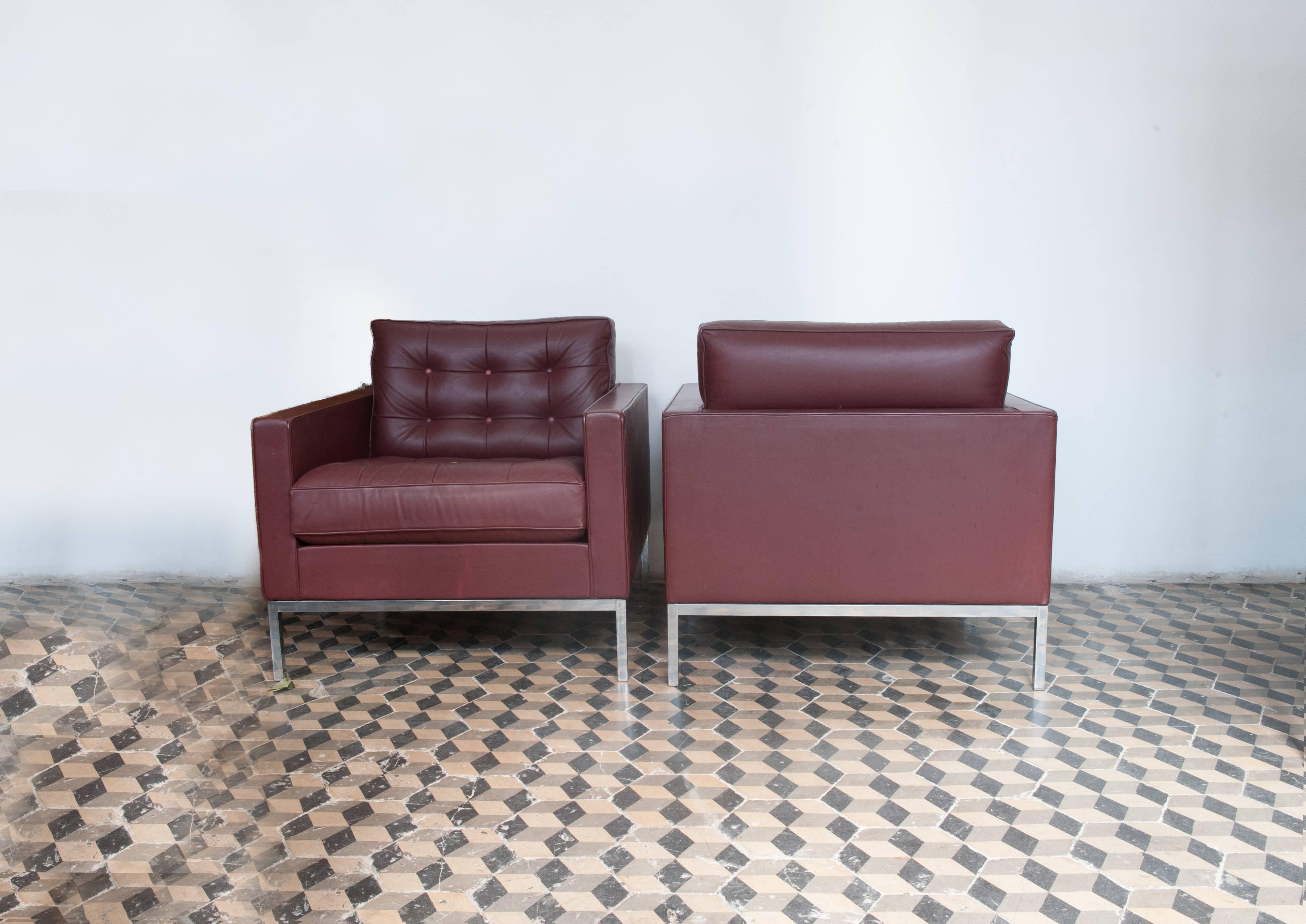 Florence Knoll club lounge chairs are a timeless example of a midcentury American design, fully tufted leather seat and back covering attached to an exposed metal chromed frame and legs. In original good condition. Signed by Knoll 1980s.