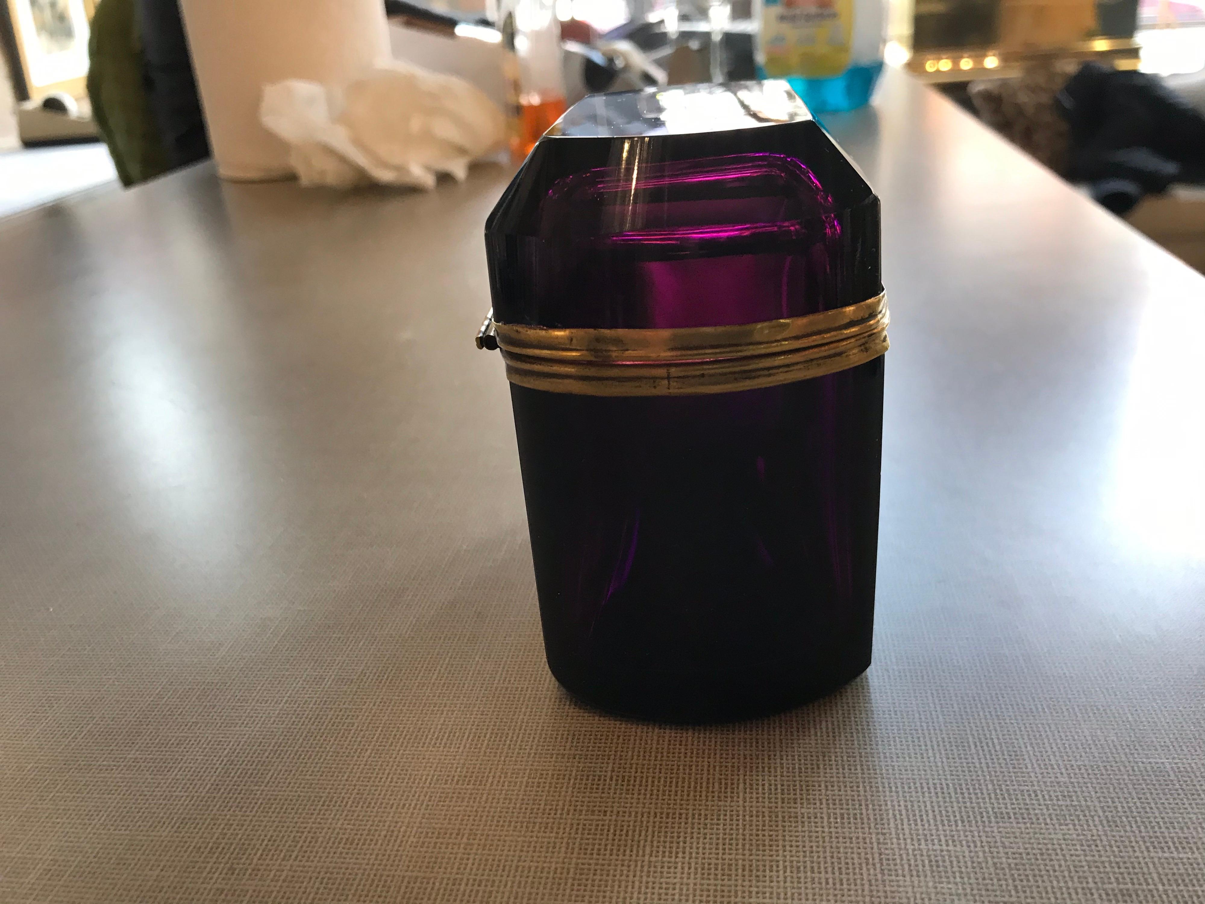 This is a lovely aubergine colored Murano glass box with brass banding ormolu.