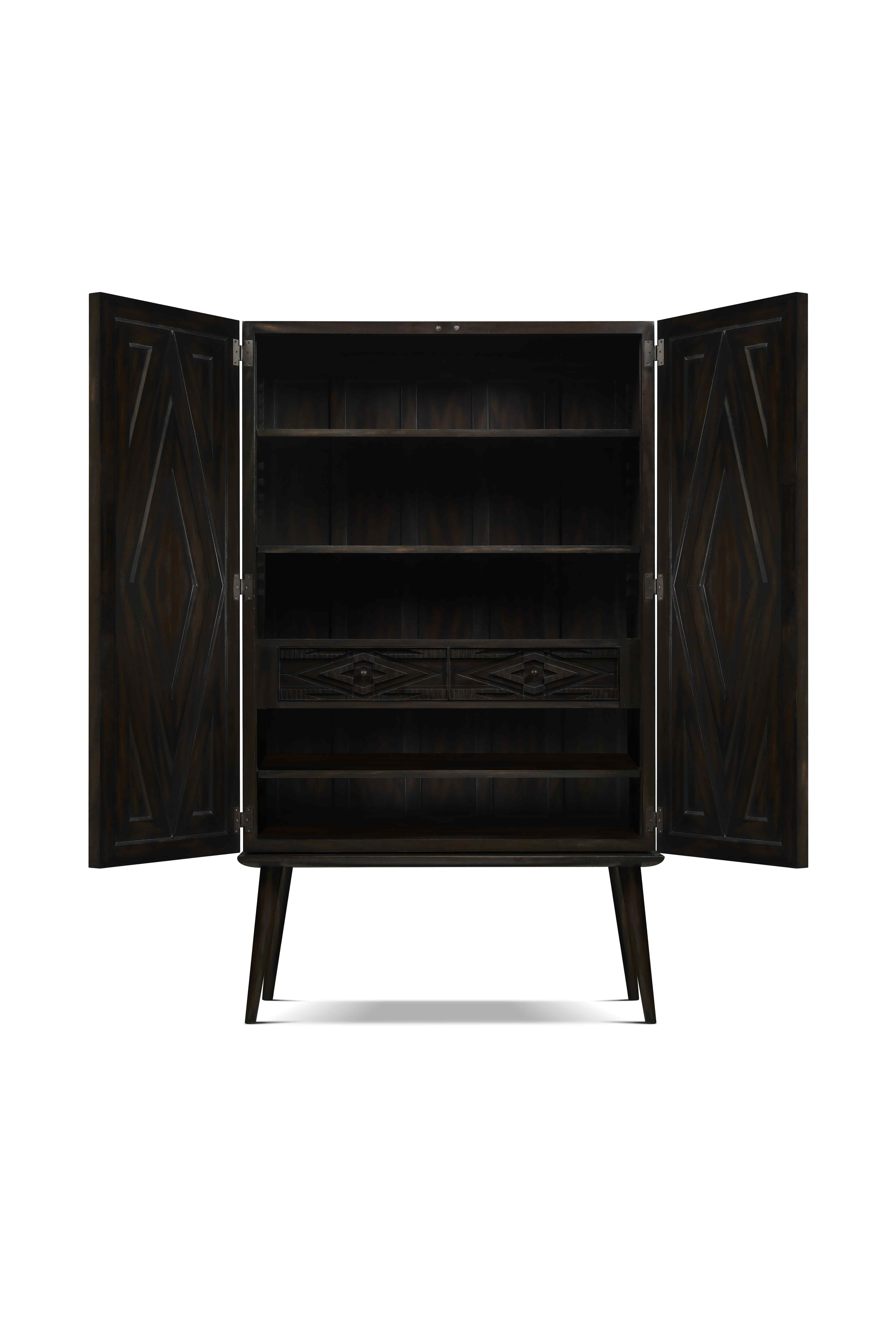 Beautiful decorated Armoire achieved by the use of different moldings in different planes creating a complex geometric design. It has a simple base with hand turned legs that give it balance, combining simplicity and texture.