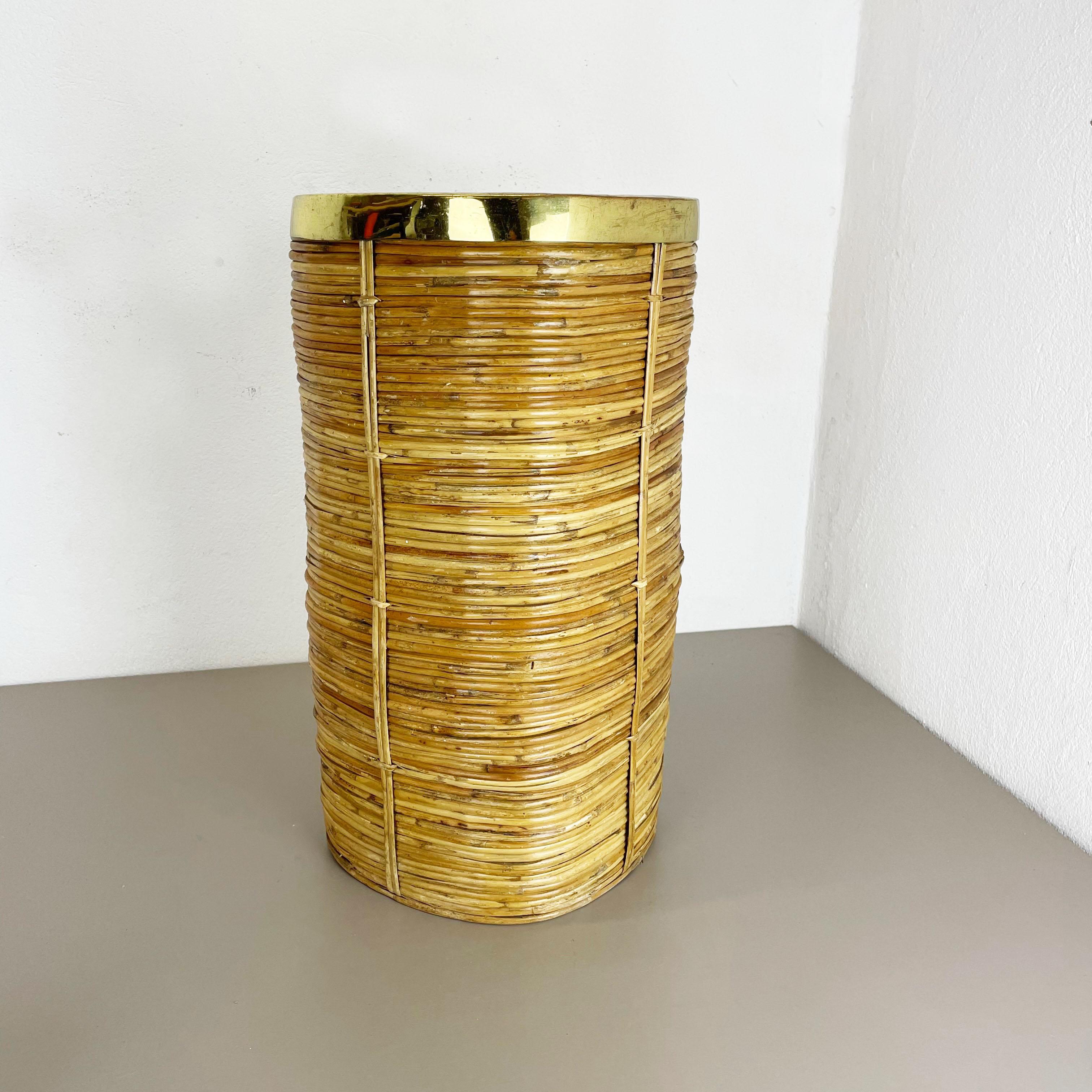 Article: waste bin paper bin

Origin: France

Age: 1960s

This original vintage Bauhaus style waste bin paper bin was produced in the 1960s in France. It is made of natural rattan with a brass applications at the top edge ring. this item has a
