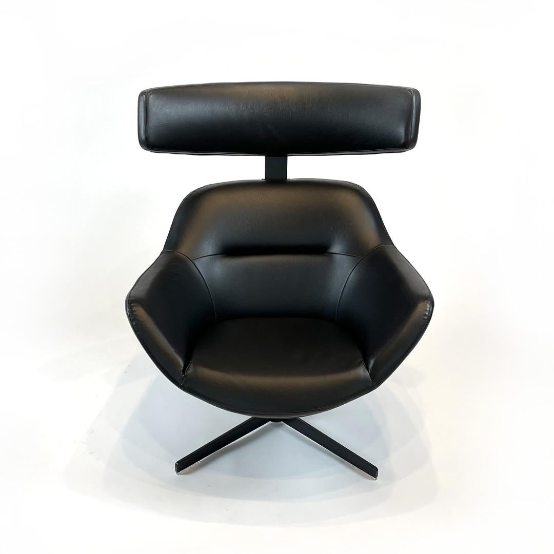 Auckland Swivel Armchair and Ottoman by Jean Marie Massaud for Cassina
Designed in 2005

Black Leather Upholstery
Black Powder-Coated Metal Frame and Base
Glossy Black Shell  
Adjustable Headrest (Eight Height Positions)

The Auckland's exposed