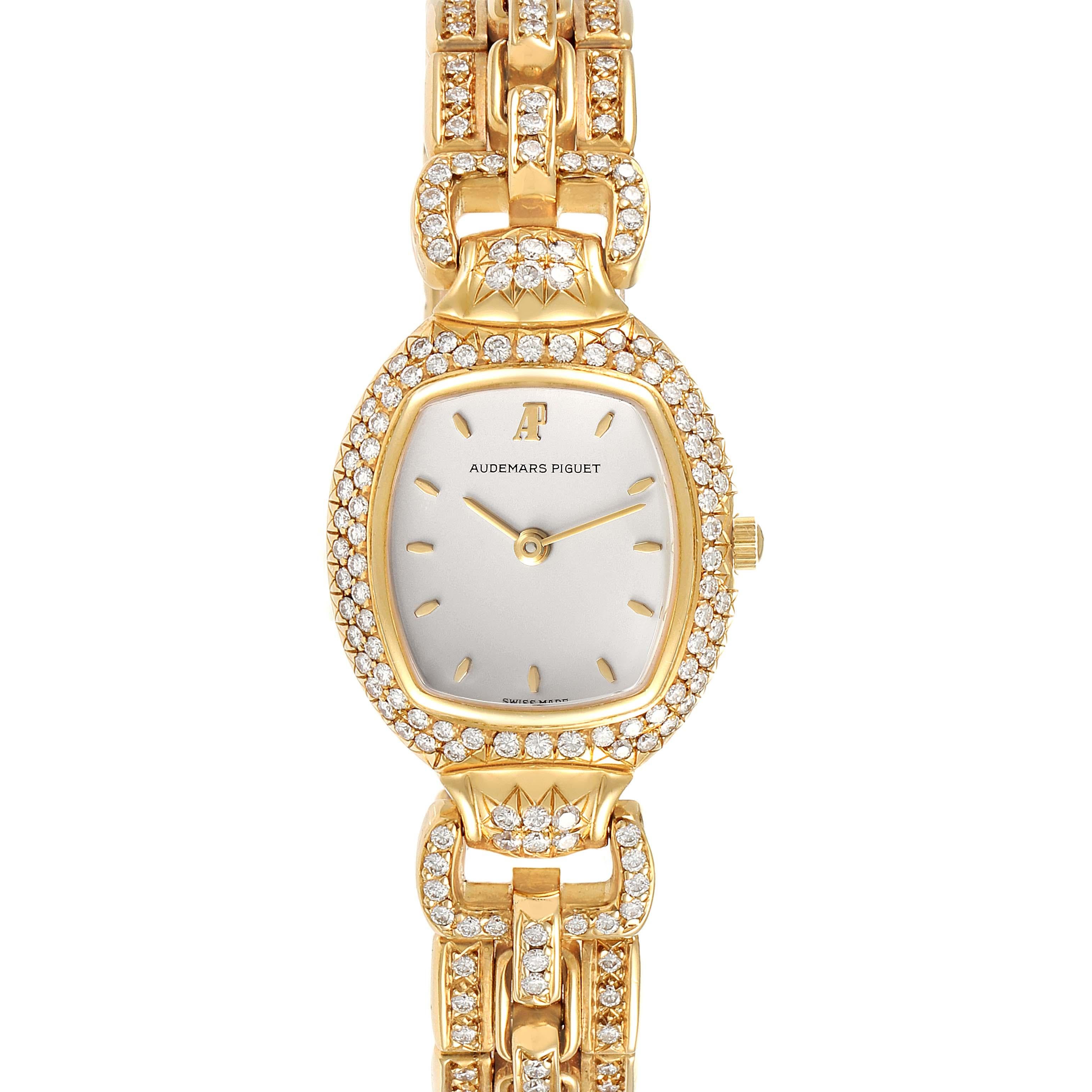Audemars Piguet Audemarine Yellow Gold Diamond Ladies Watch 66474. Quartz movement. 18k yellow gold oval case 23 mm X 35.0mm. 18k yellow gold diamond bezel. Scratch resistant sapphire crystal. Silver dial with raised yellow gold hour baton markers.