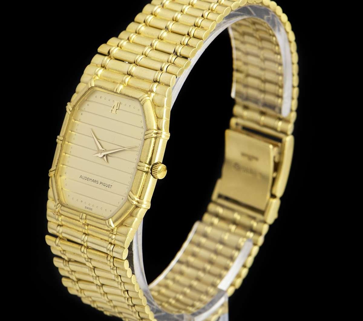 An 18k Yellow Gold Bamboo Vintage Gents Wristwatch, champagne tapestry dial, a fixed 18k yellow gold bezel, an 18k yellow gold integrated bracelet with an 18k yellow gold jewellery style clasp, mineral glass, quartz movement, in excellent condition,