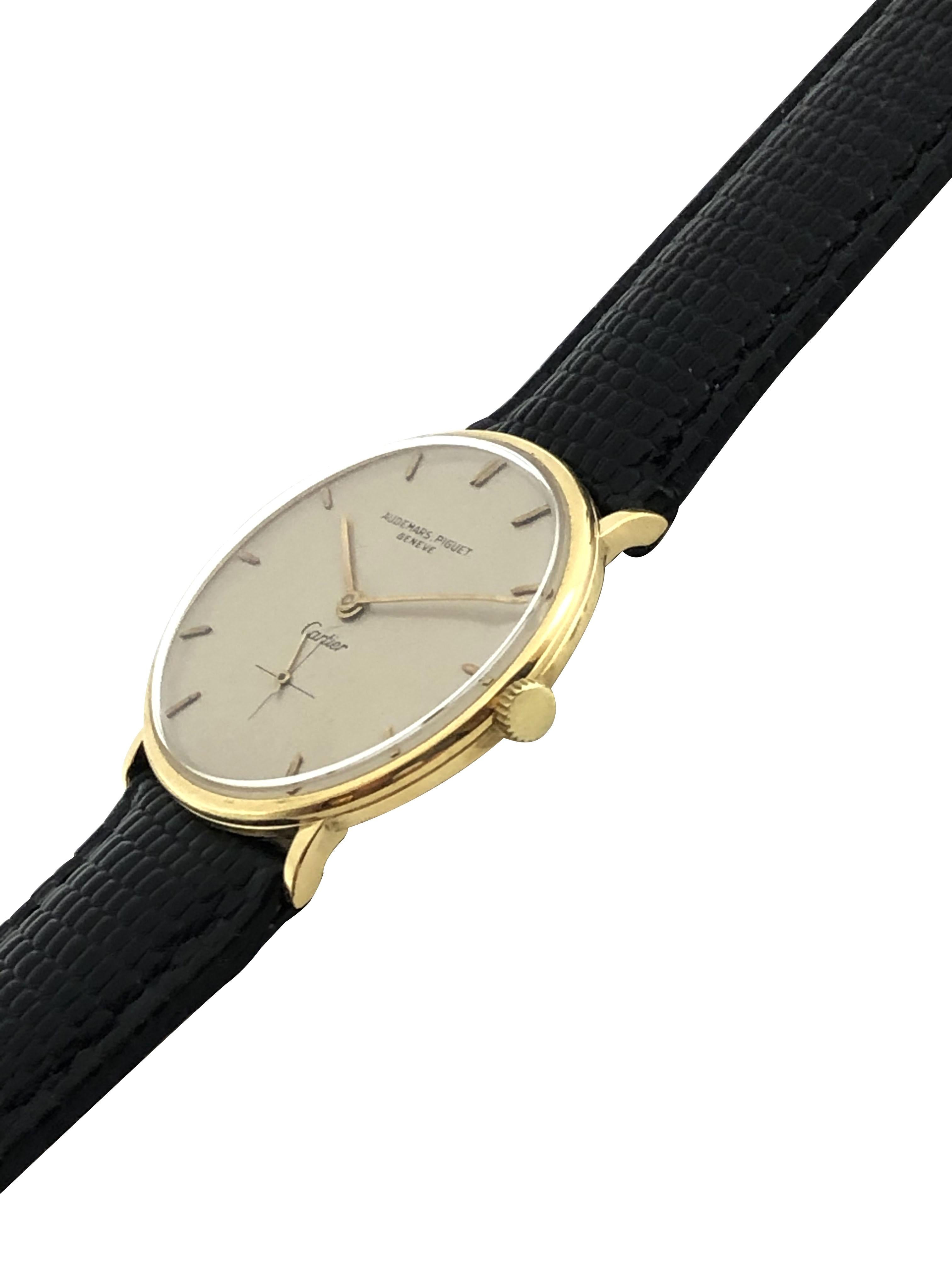 Circa 1950s Audemars Piguet Retailed by Cartier Wrist Watch, 32 M.M. 18K Yellow Gold 3 Piece case, 18 Jewel Mechanical, Manual wind Nickle Lever movement. Silver Satin Dial with Raised Gold Markers and a sub seconds sweep hand. New Hadley Roma Black
