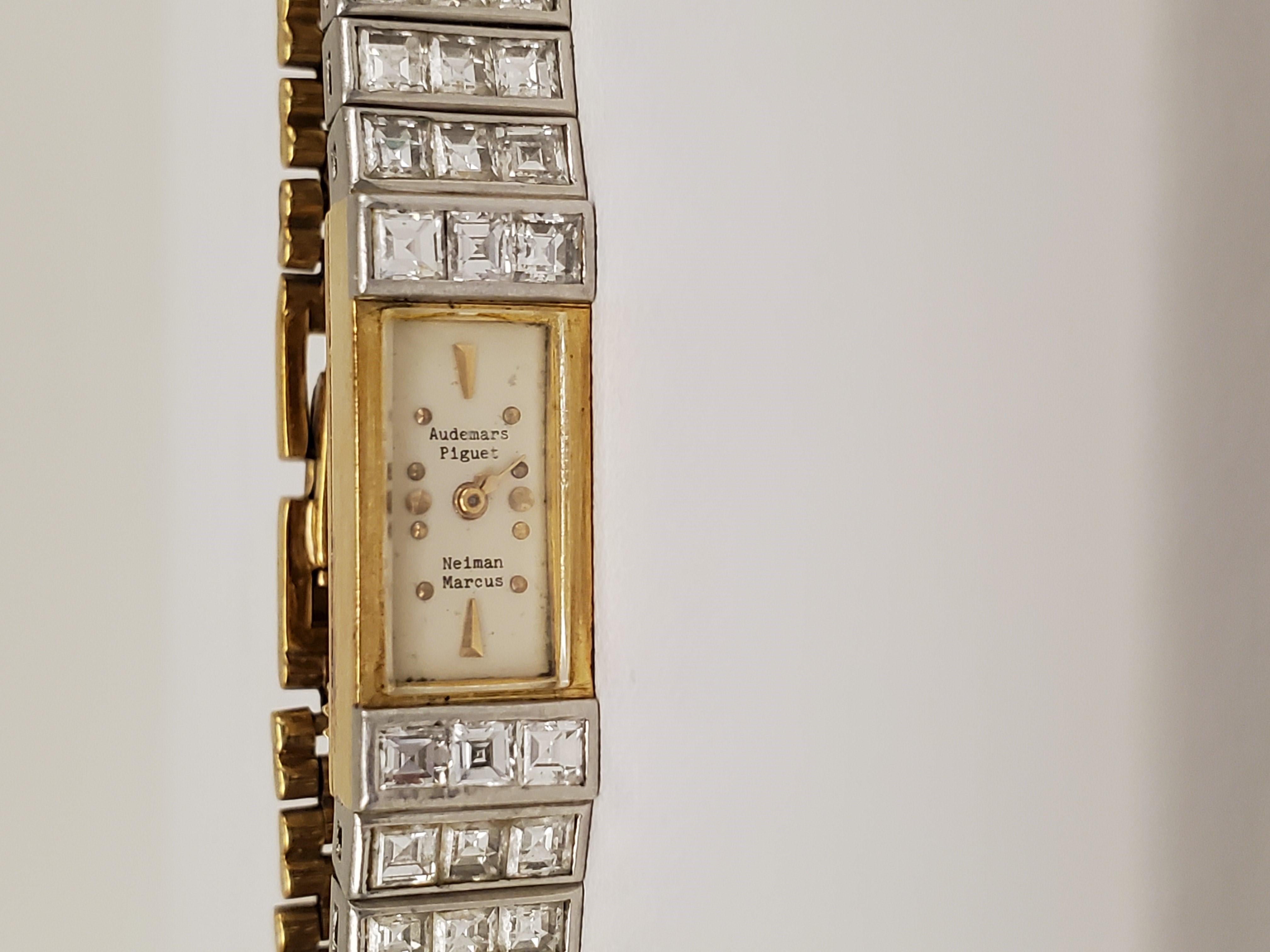 Elegant vintage Audemars Piguet watch crafted in 18 carat yellow gold and platinum. The watch is set with approximately 1.80 carats of square emerald cut diamonds (G-H color, VS clarity). The dial is signed Audemars Piguet. Retailed by Neiman