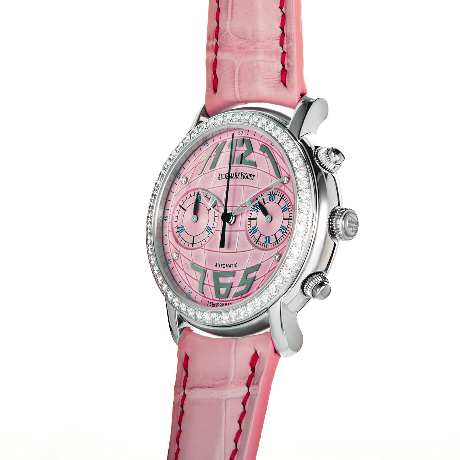 Pretty and pink, this Jules Audemars Ladies Chronograph is sure to please! The watch's round case is made of 18K white gold and boasts a bezel set with a row of 57 diamonds. The watch's dial looks like a pink globe and displays chronograph sub-dials