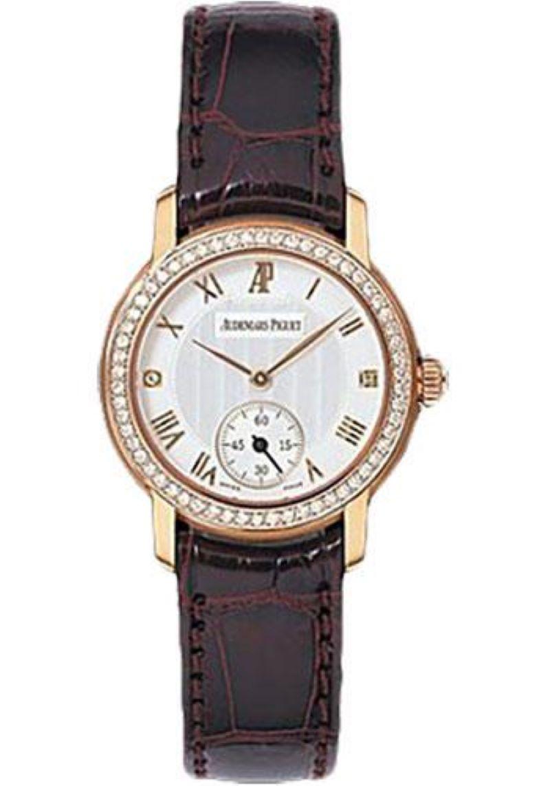 27mm rose gold case, rose gold bezel, silver dial with roman hour markers, small seconds at 6 o'clock, manual winding movement with hours, minutes, seconds, burgandy leather strap. Water resistant to 20 meters.