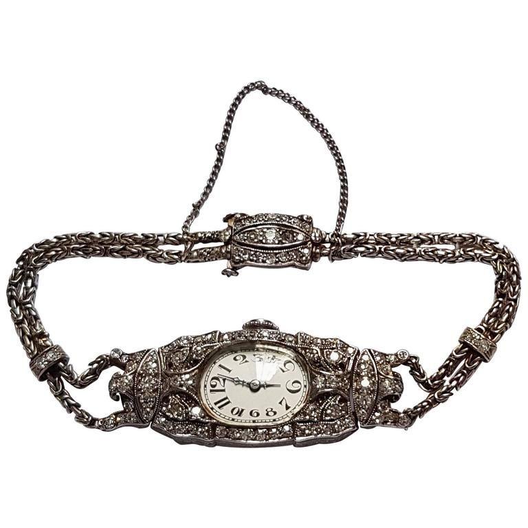 This delicate Audemars Piguet Art Deco Ladies Watch with Byzantine double rope chain (including safety chain) shows extraordinary craftsmanship. The watch is made of platinum and diamonds, the dial is silvered with Arabic numerals. It was recently