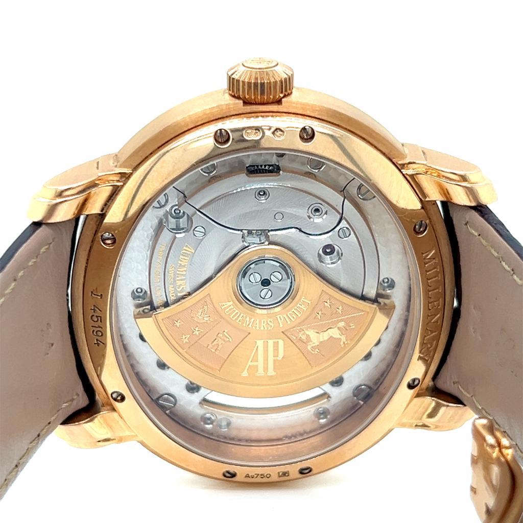 The Audemars Piguet Millenary Skeleton 18KT Rose Gold 4101 Automatic watch is a stunning masterpiece, seamlessly merging artistry and engineering. Its 18KT rose gold case features polished screws on the bezel, highlighting its unique oval shape,