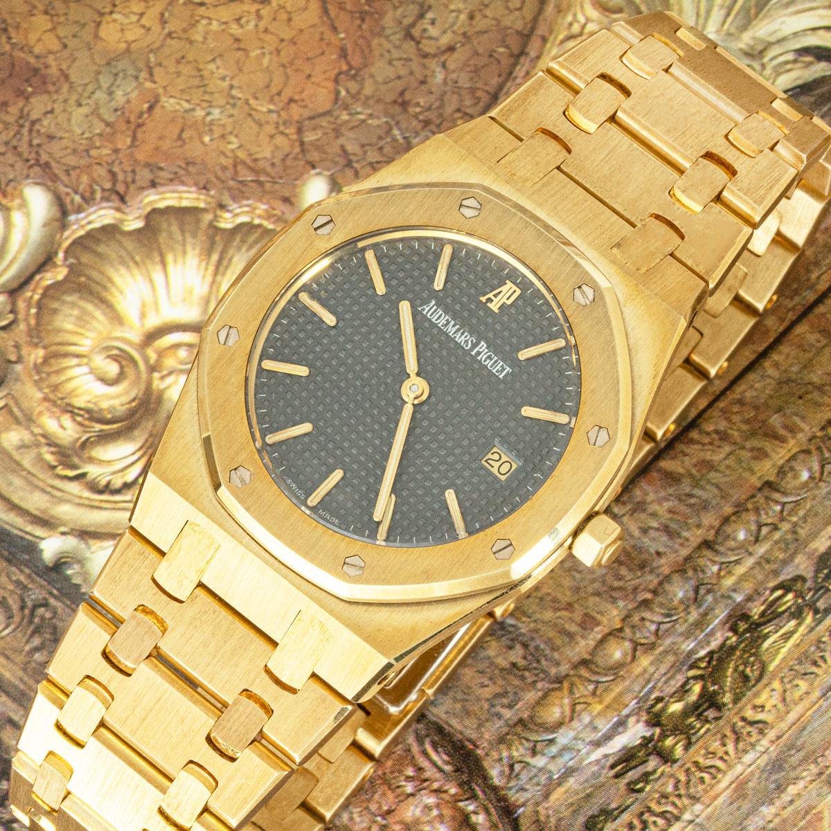 A 33mm yellow gold Royal Oak by Audemars Piguet. Featuring an anthracite dial with a tapisserie pattern and a date display at 3 o'clock. The bezel features the iconic 8 screw design which is now synonymous with Audemars Piguet.

The bracelet comes