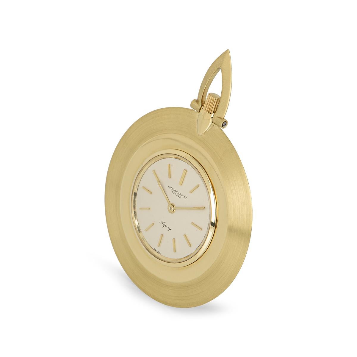 A vintage open face dress 41mm pocket watch in yellow gold by Audemars Piguet, retailed by Asprey. Featuring a silver dial with mineral glass. Fitted with a manual wind movement which is shown close up in the photos.

The piece is in excellent