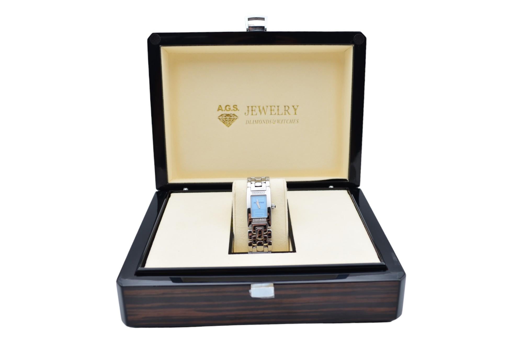 The watch is in a very good condition and it’s working well. The total length of the bracelet (case+bracelet) is 16cm. It shows slight signs of wear. The watch comes with an AGS Jewelry wooden box, along with an AGS Jewelry warranty card. For more