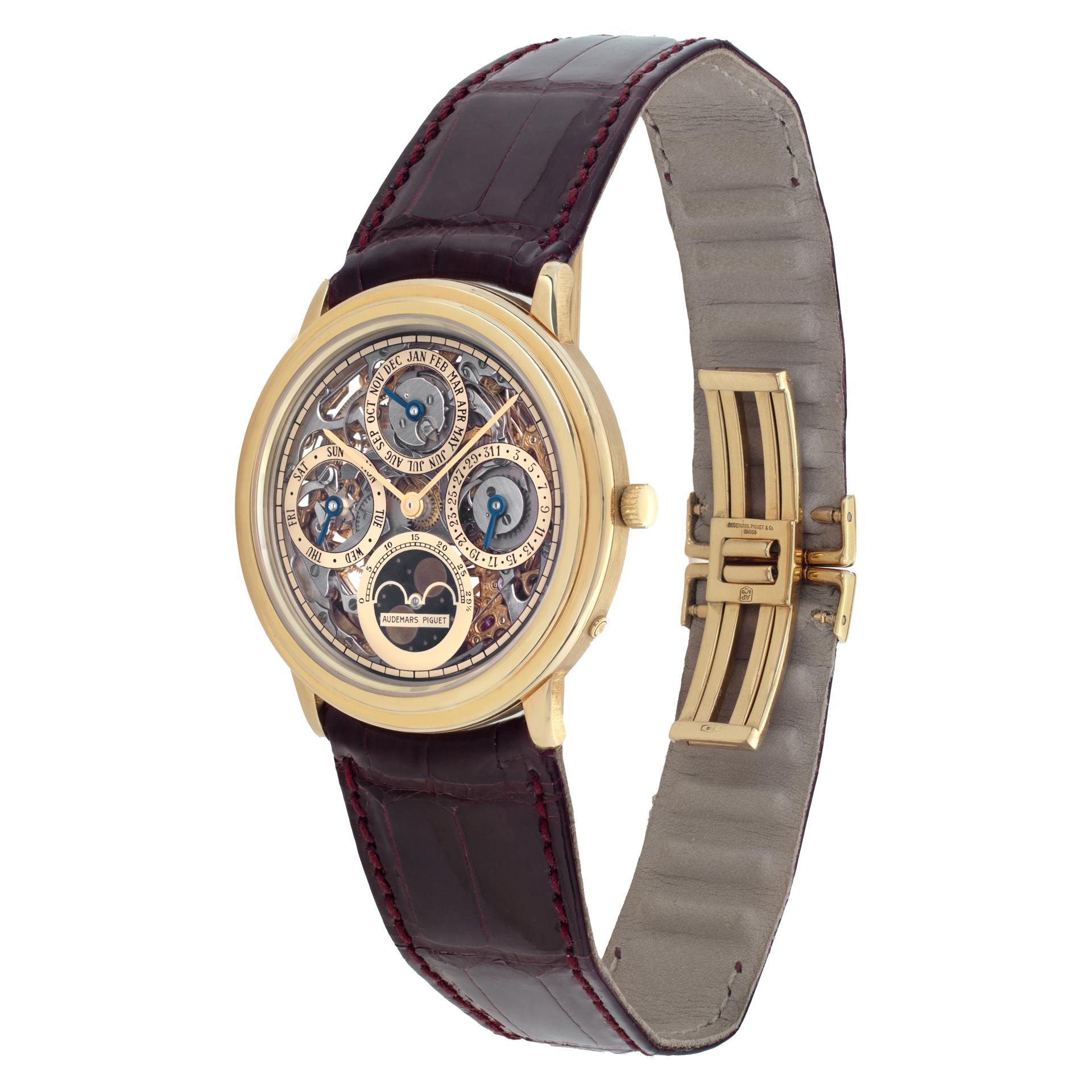 Rare Audemars Piguet Quantième Perpétuel Automatique Skeleton in 18k yellow gold on a brand new, uncut, burgundy alligator strap with AP 18k deployant buckle. Automatic movement with Calibre 2120/2, adjusted to heat, cold, isochronism and 5