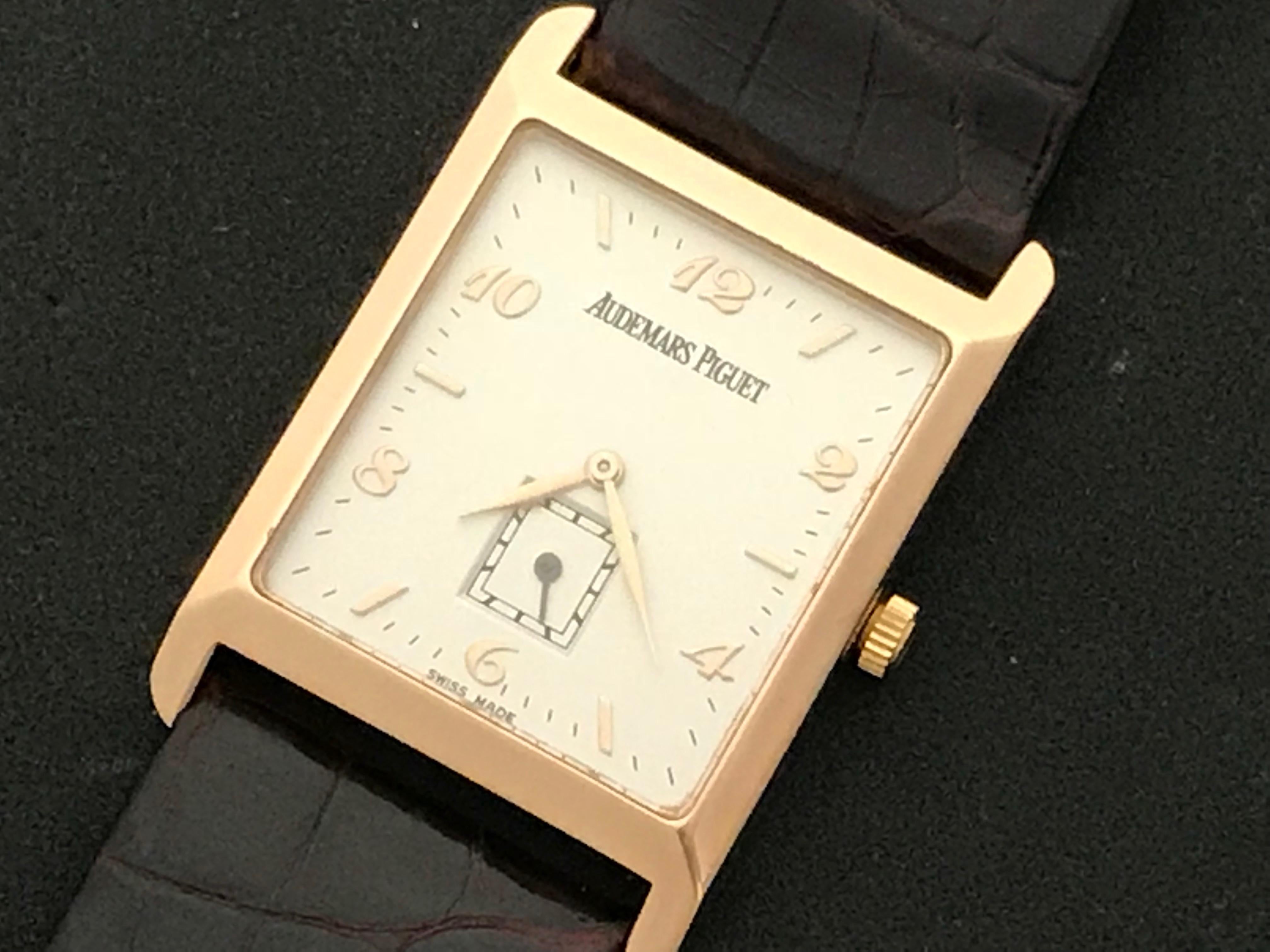 Audemars Piguet Pre Owned Mens Manual Winding wrist watch. Silvered Dial with rose gold hour markers and Arabic numerals, 18k Rose Gold rectangular style case (25.5x36mm). Strap band with 18k Rose gold Audemars Piguet buckle. Audemars Piguet box
